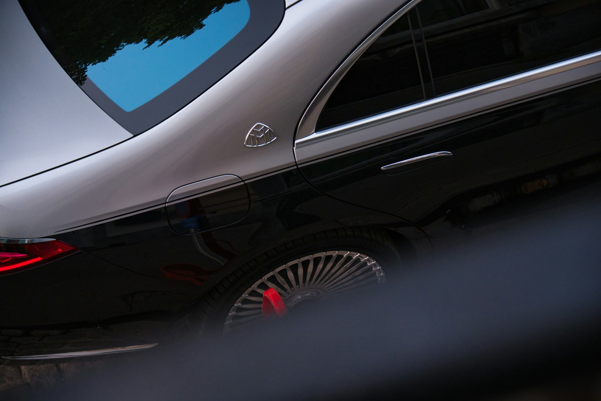 Luxury car with distinctive emblem and wheel detail.
