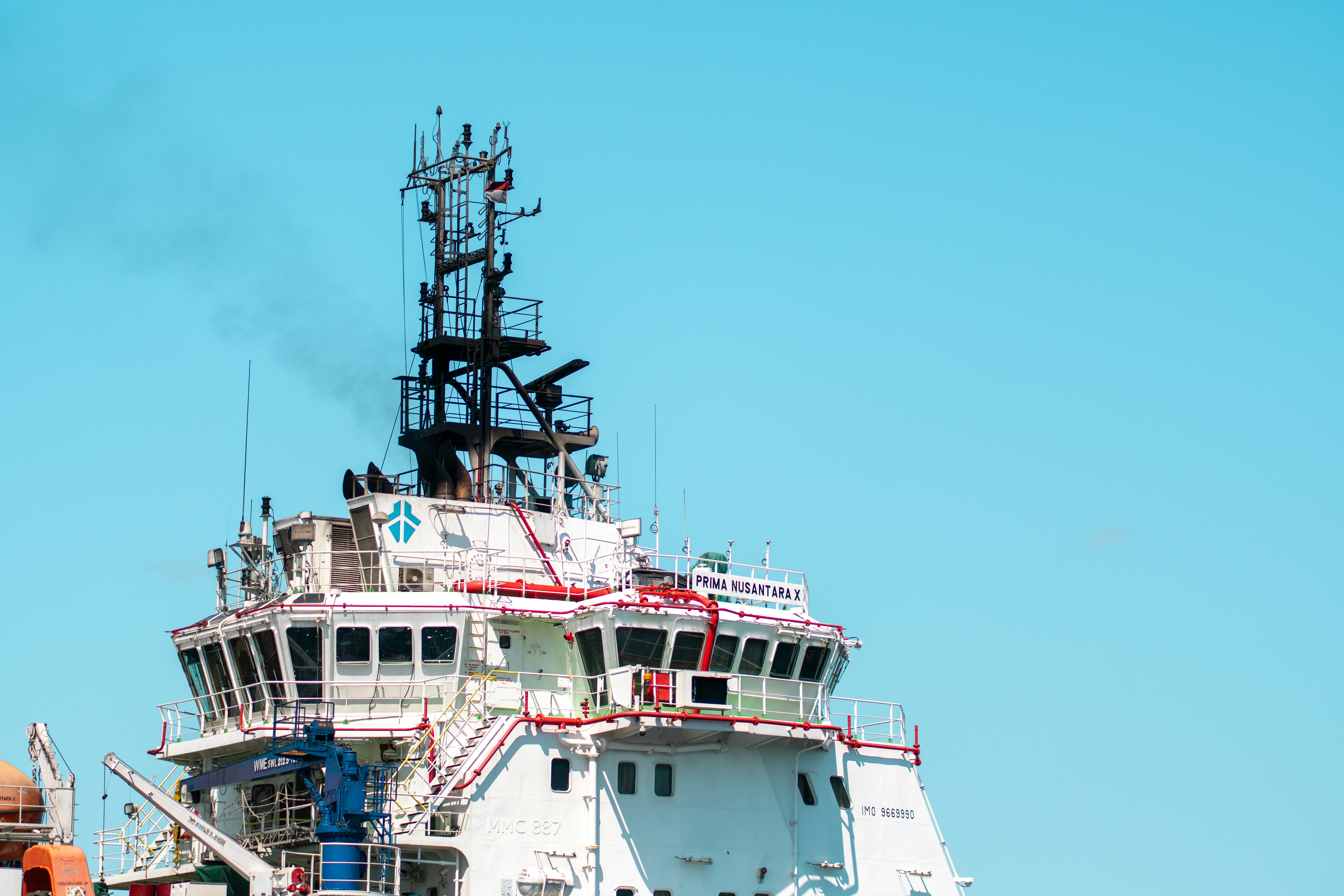 Ship's bridge with antennas against a clear blue sky