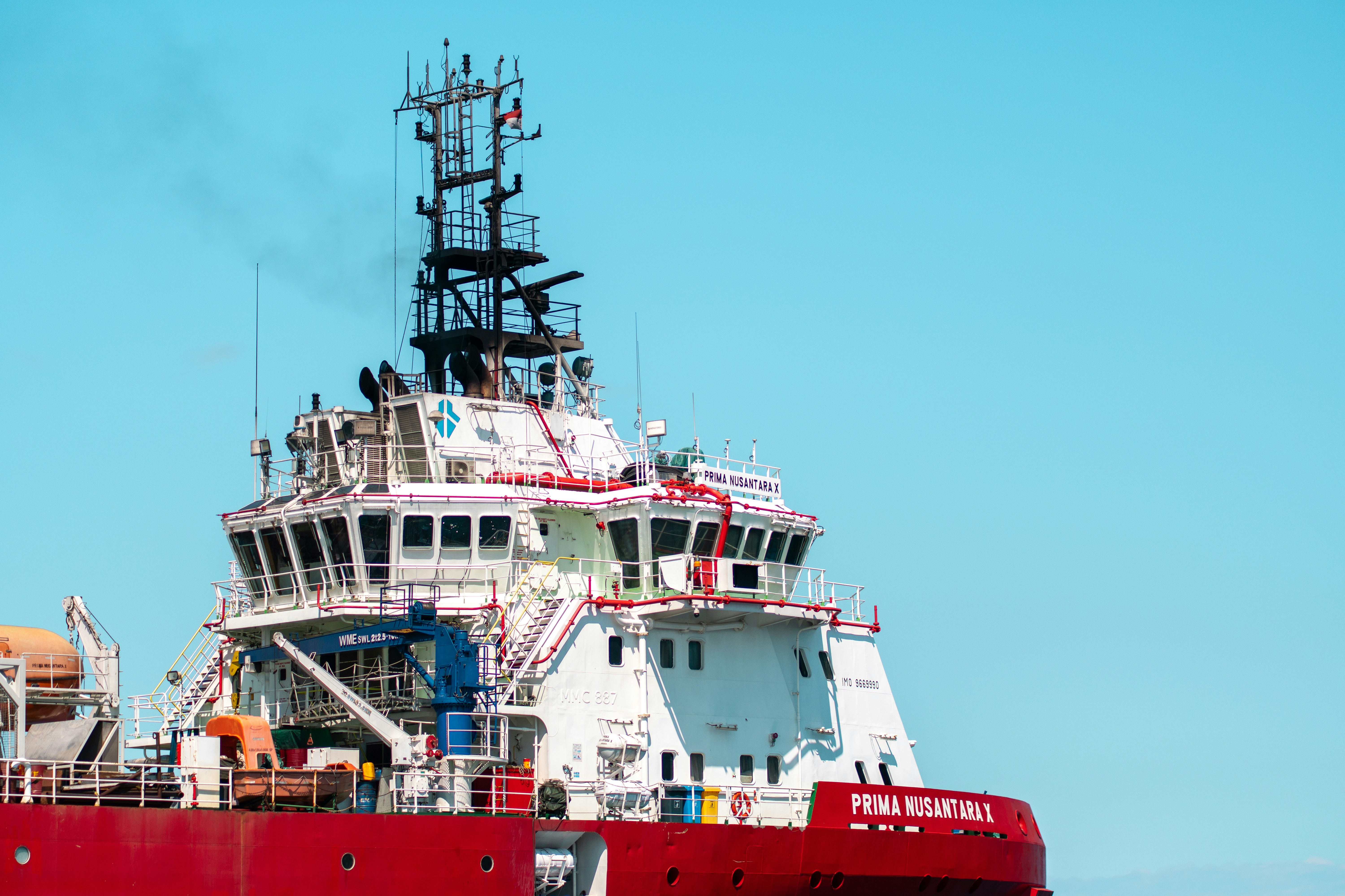 A large red and white ship sailing on the ocean