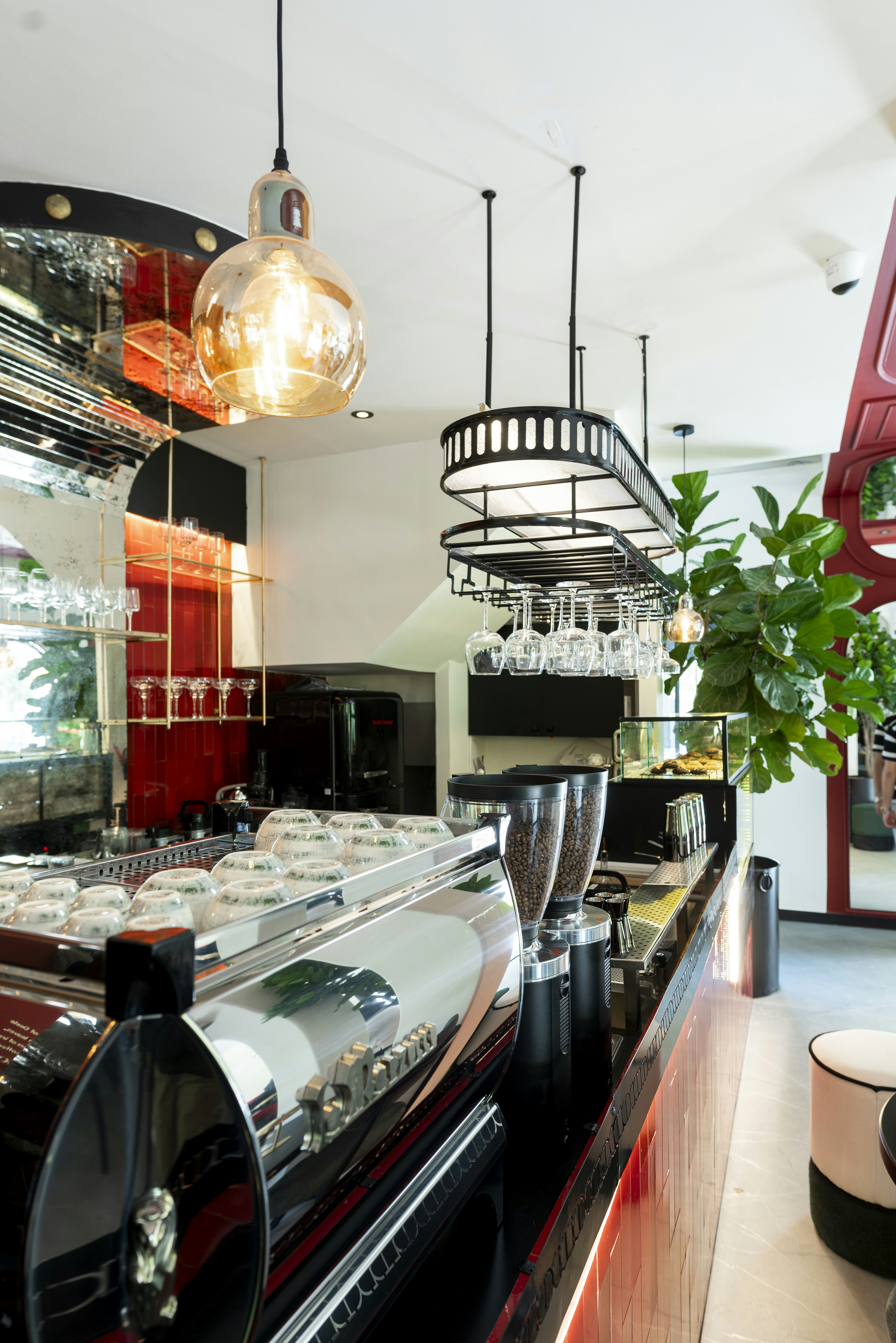 Modern coffee bar with espresso machine and glassware