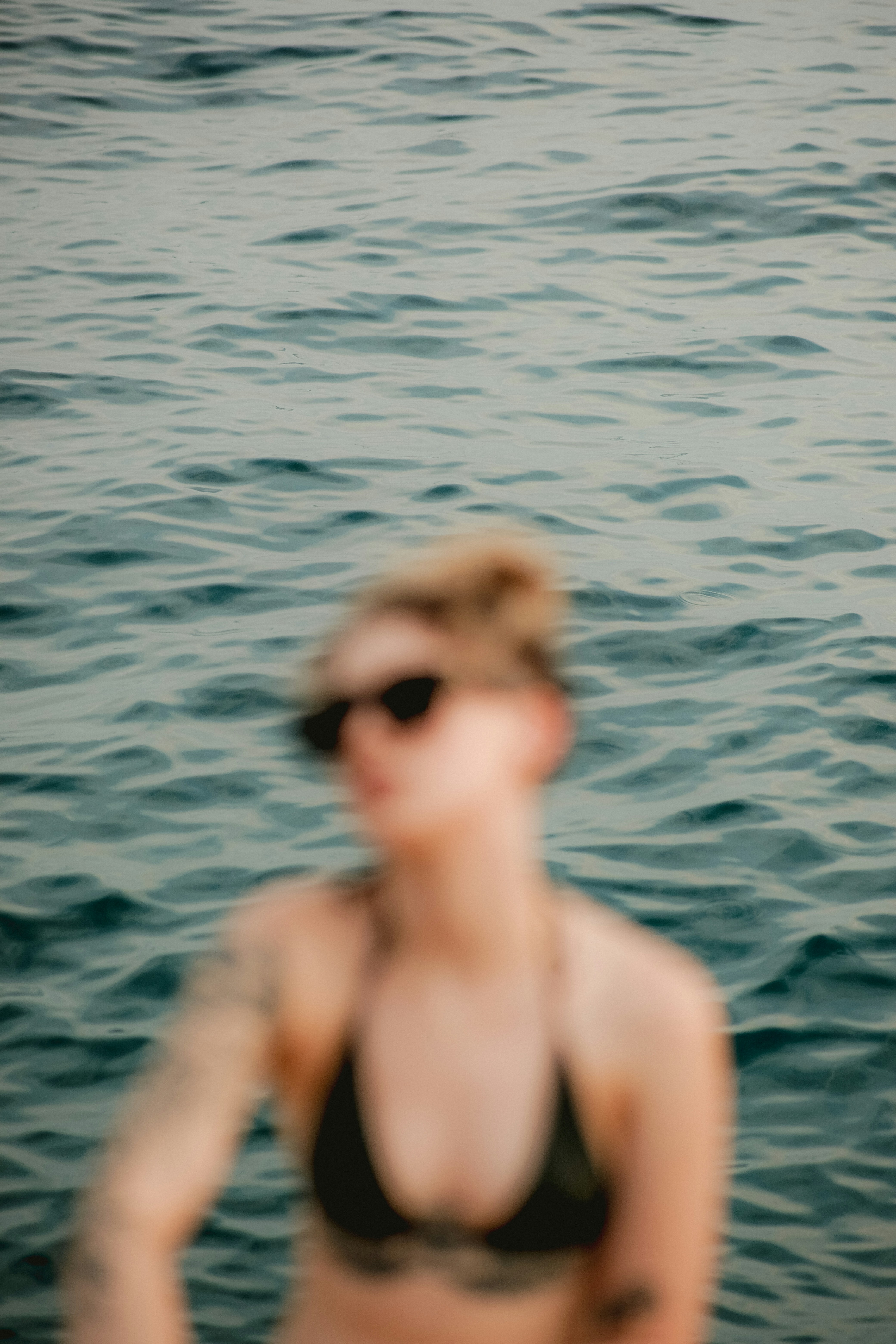 Woman in bikini and sunglasses on water