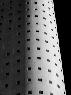 Curved building facade with repeating small windows