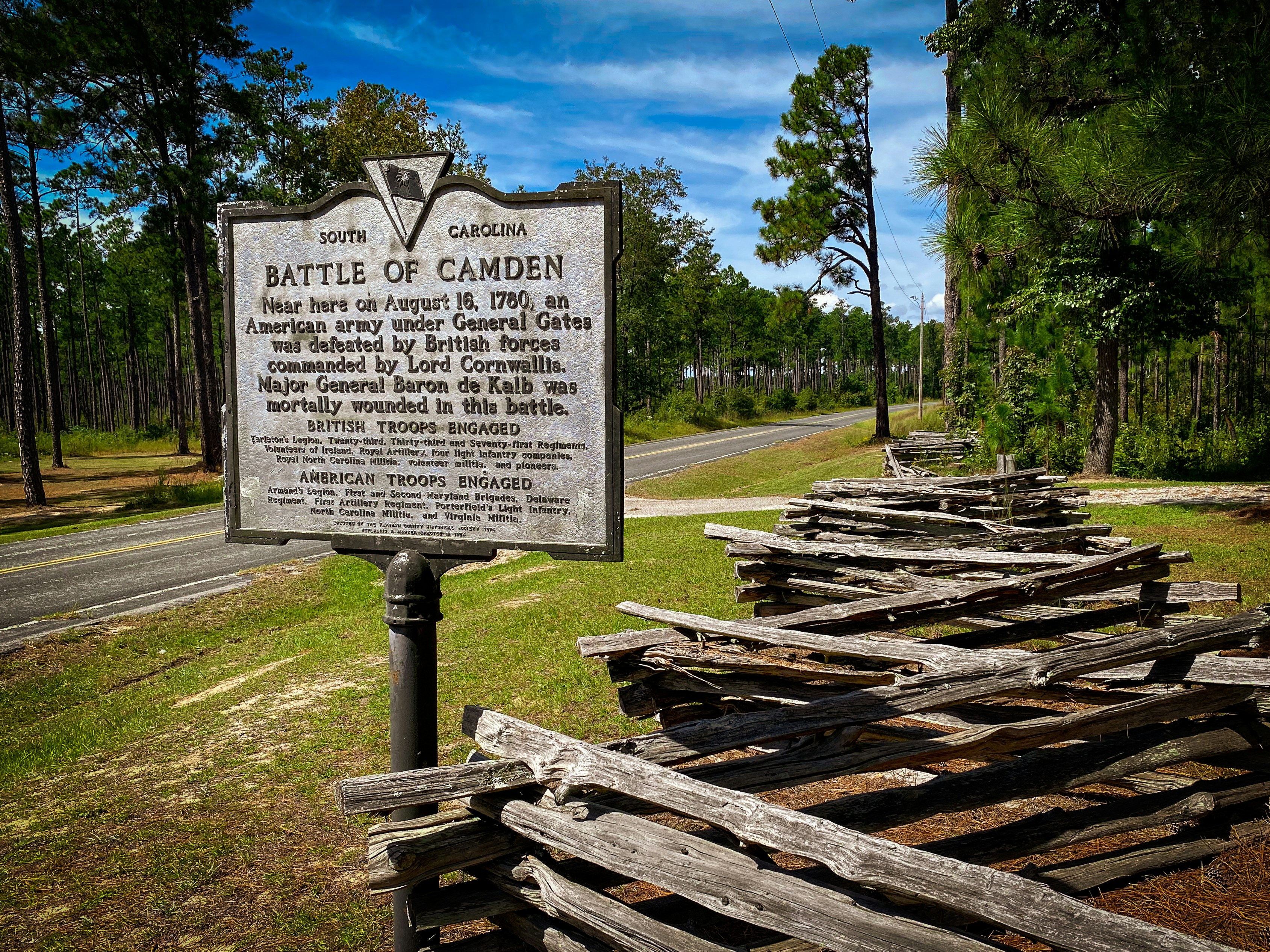 Battle of camden historical marker with wooden fence