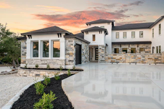 Modern luxury house with stone accents at sunset