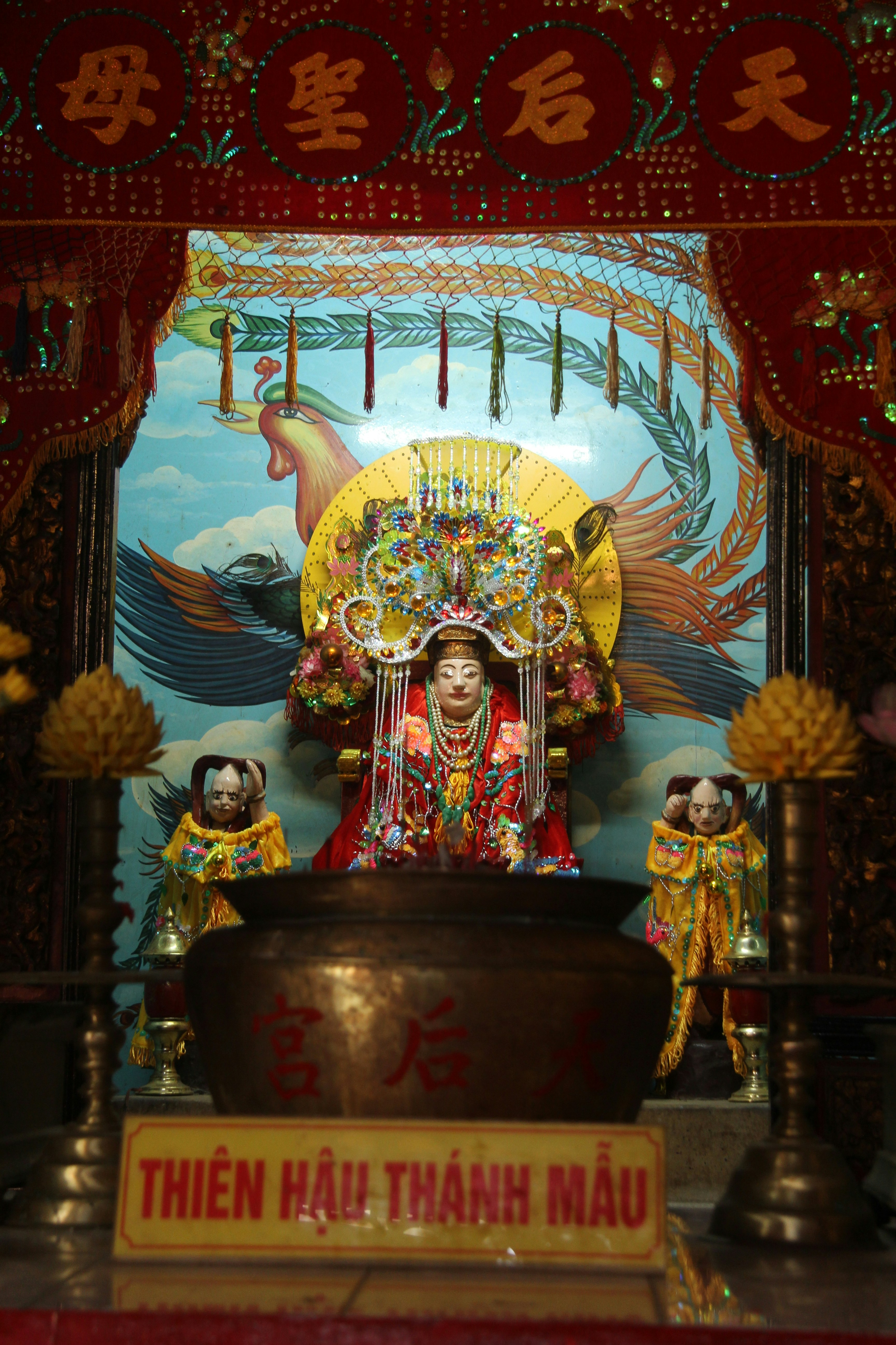 Ornate statue of a deity in a temple setting.