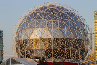 Geodesic dome structure with glass panels and metal frame.