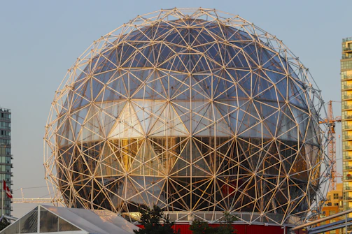Geodesic dome structure with glass panels and metal frame.