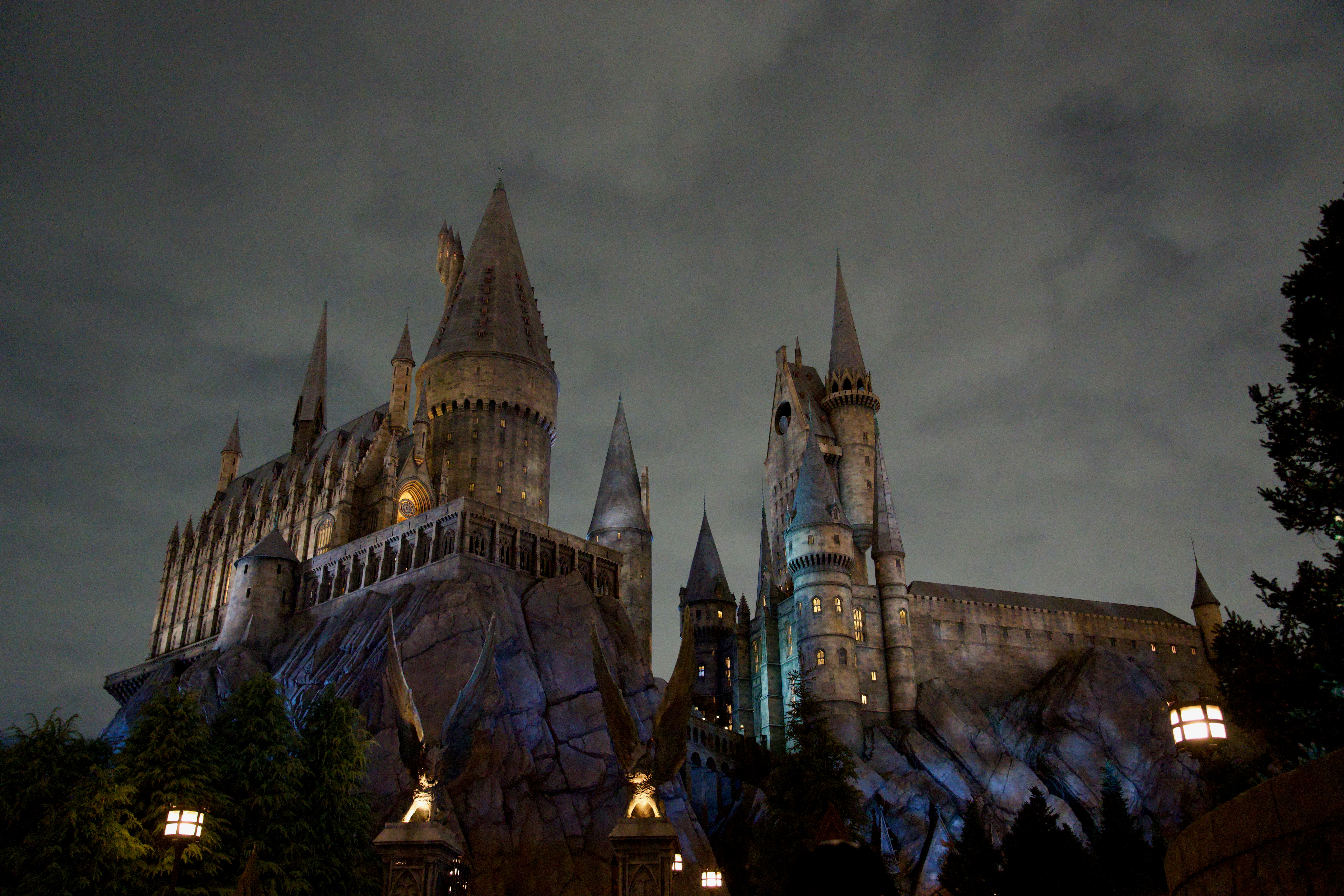 Castle illuminated against a dark, cloudy sky