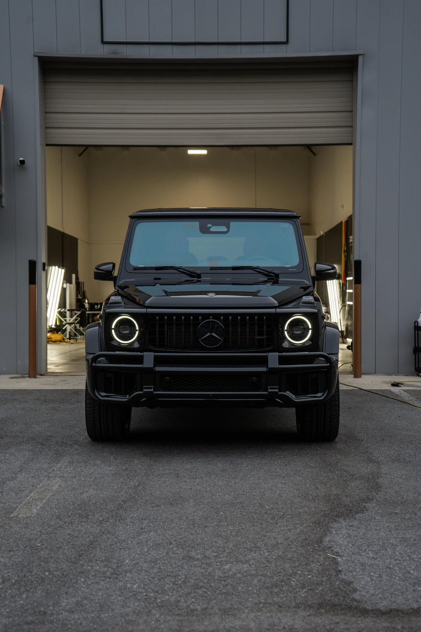 Black Mercedes-Benz G-Wagon parked outside a garage, representative of vehicles T2T transports