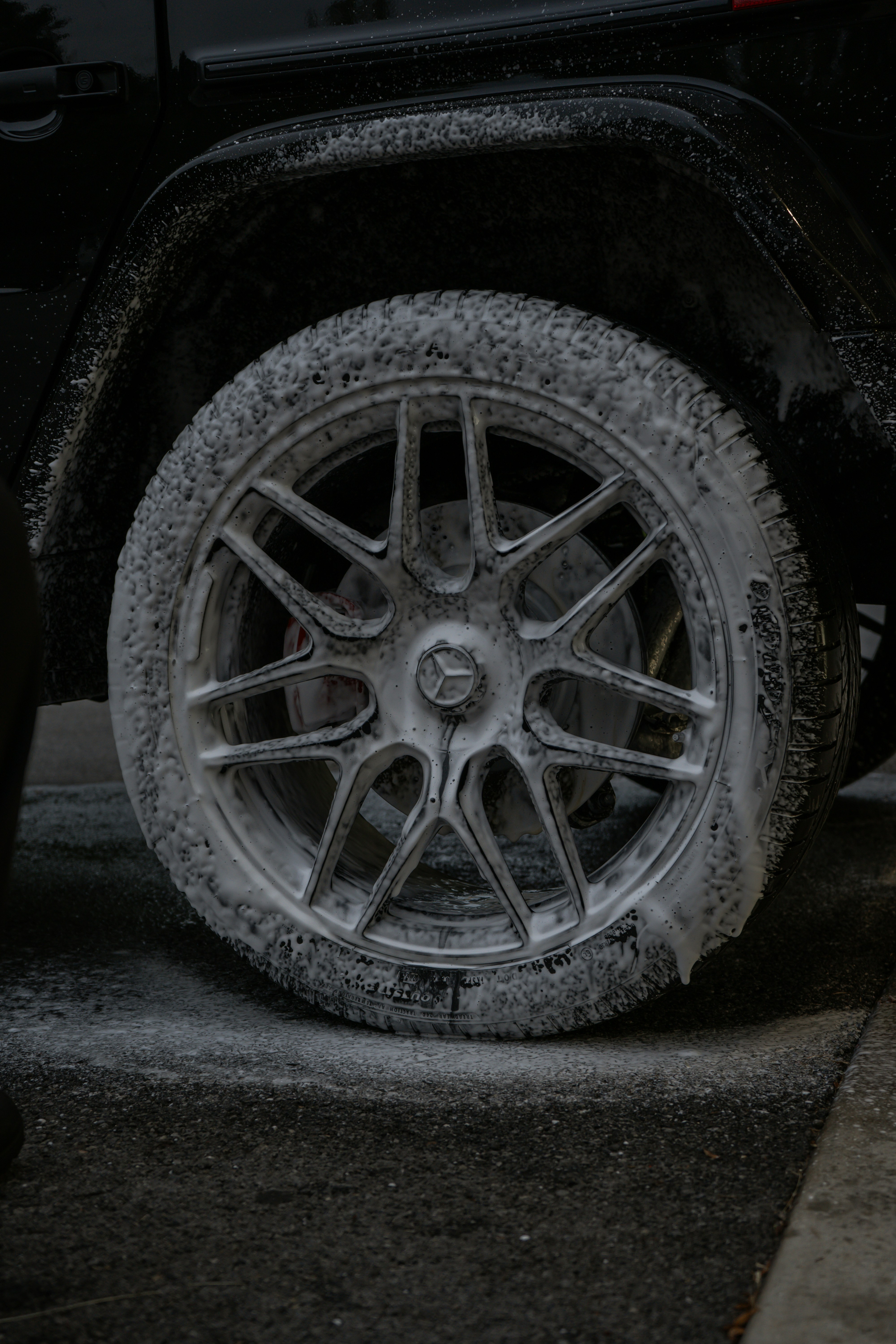 Close-up of a wheel covered in soapy foam
