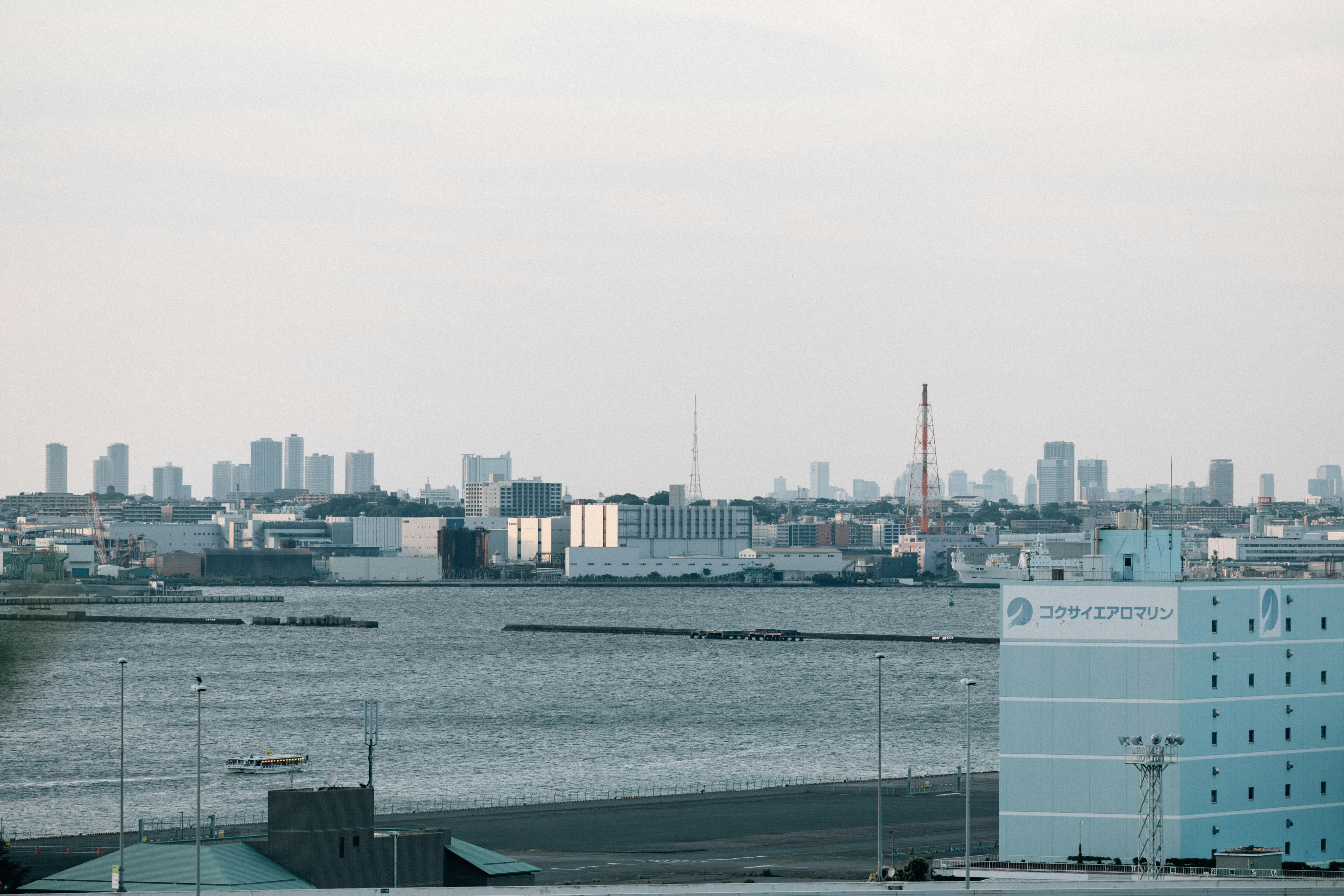 City skyline across a bay with industrial buildings.