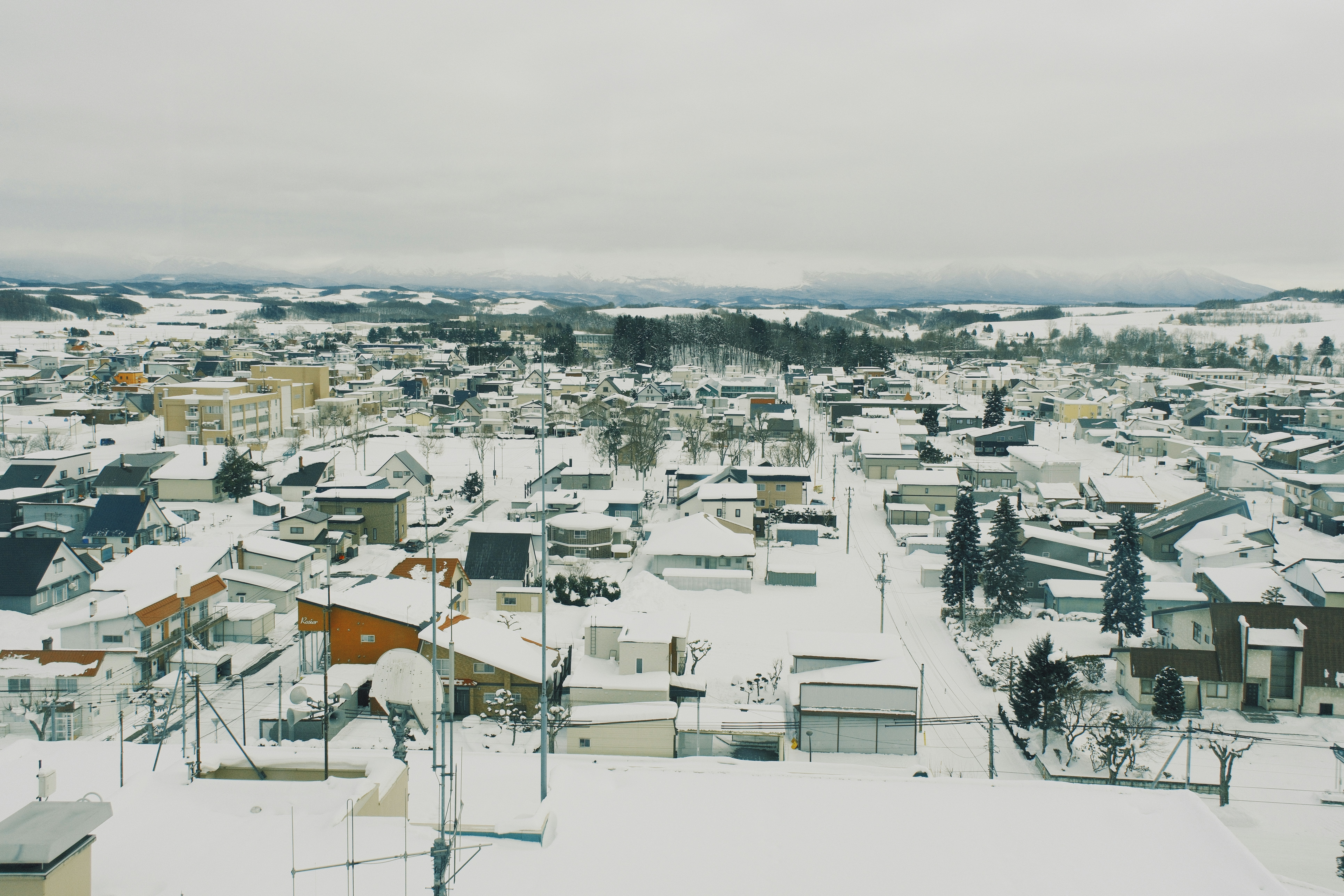 Snow-covered town with houses and streets.