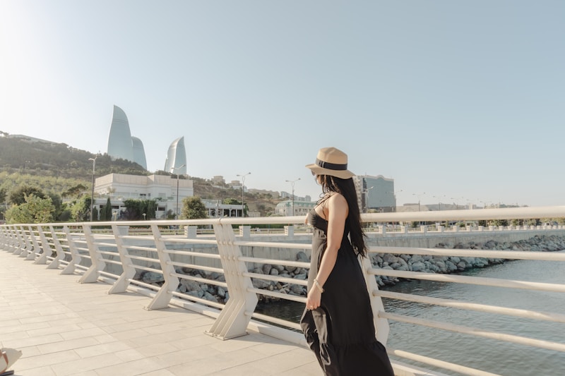 Woman in black dress on a bridge overlooking cityscape