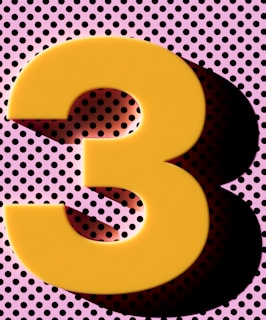 A large yellow number three casts a shadow.