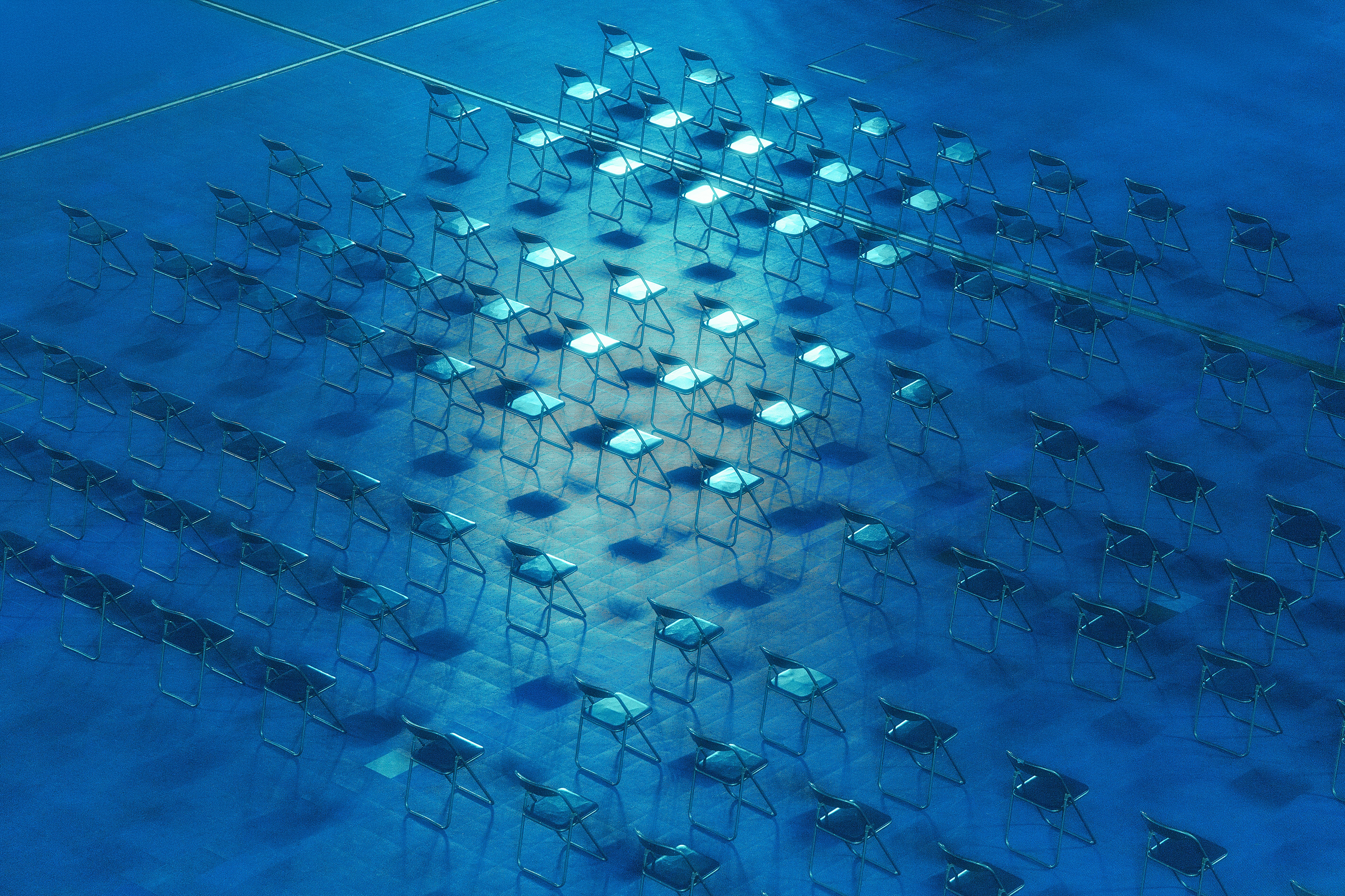 Rows of empty chairs in a large hall