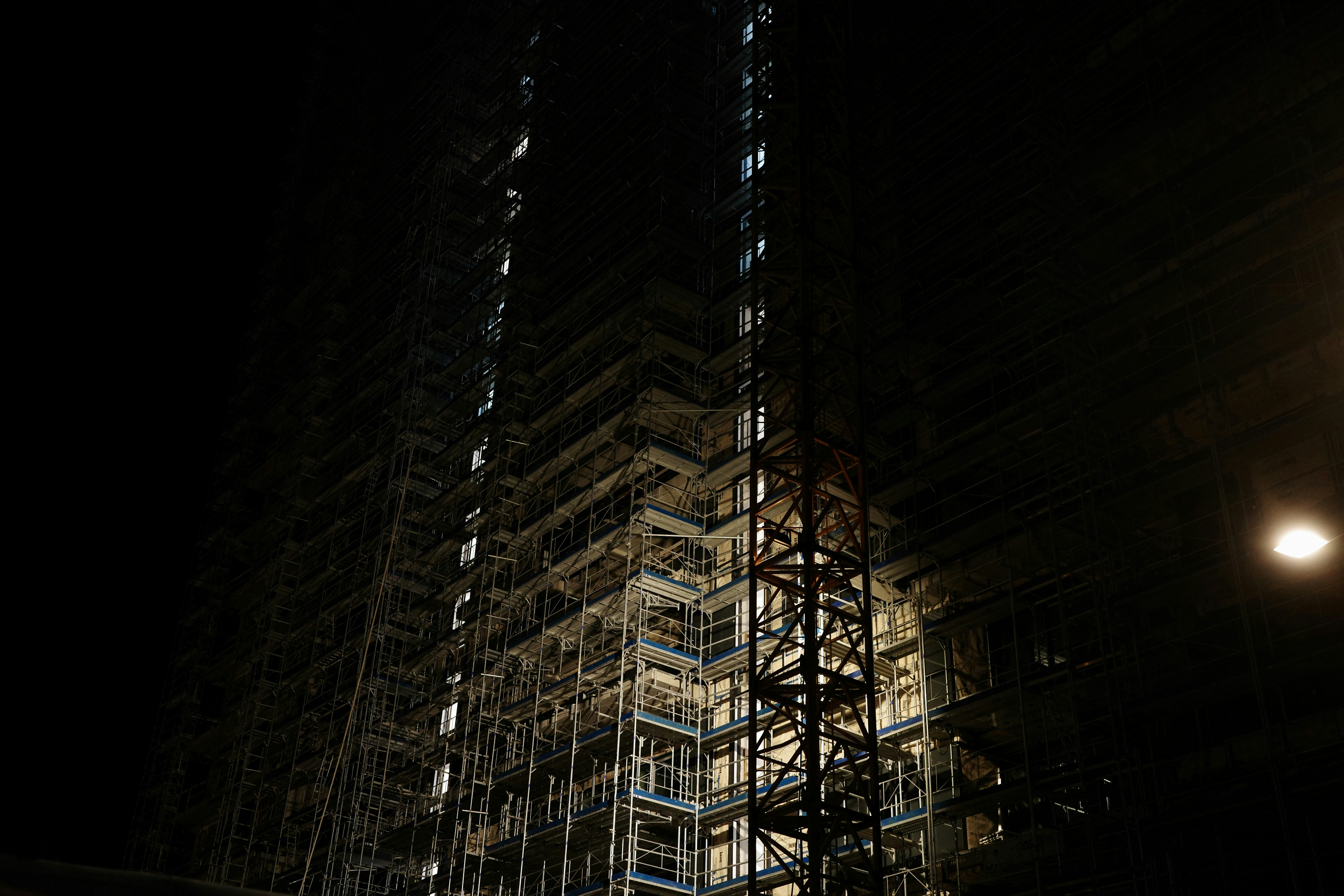 Tall building under construction at night
