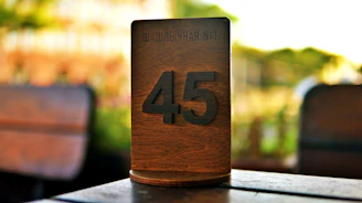 Wooden table number 45 at an outdoor cafe.