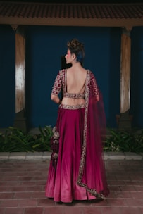 Woman in ornate magenta lehenga with blue hair
