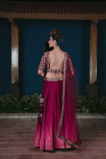 Woman in ornate magenta lehenga with blue hair