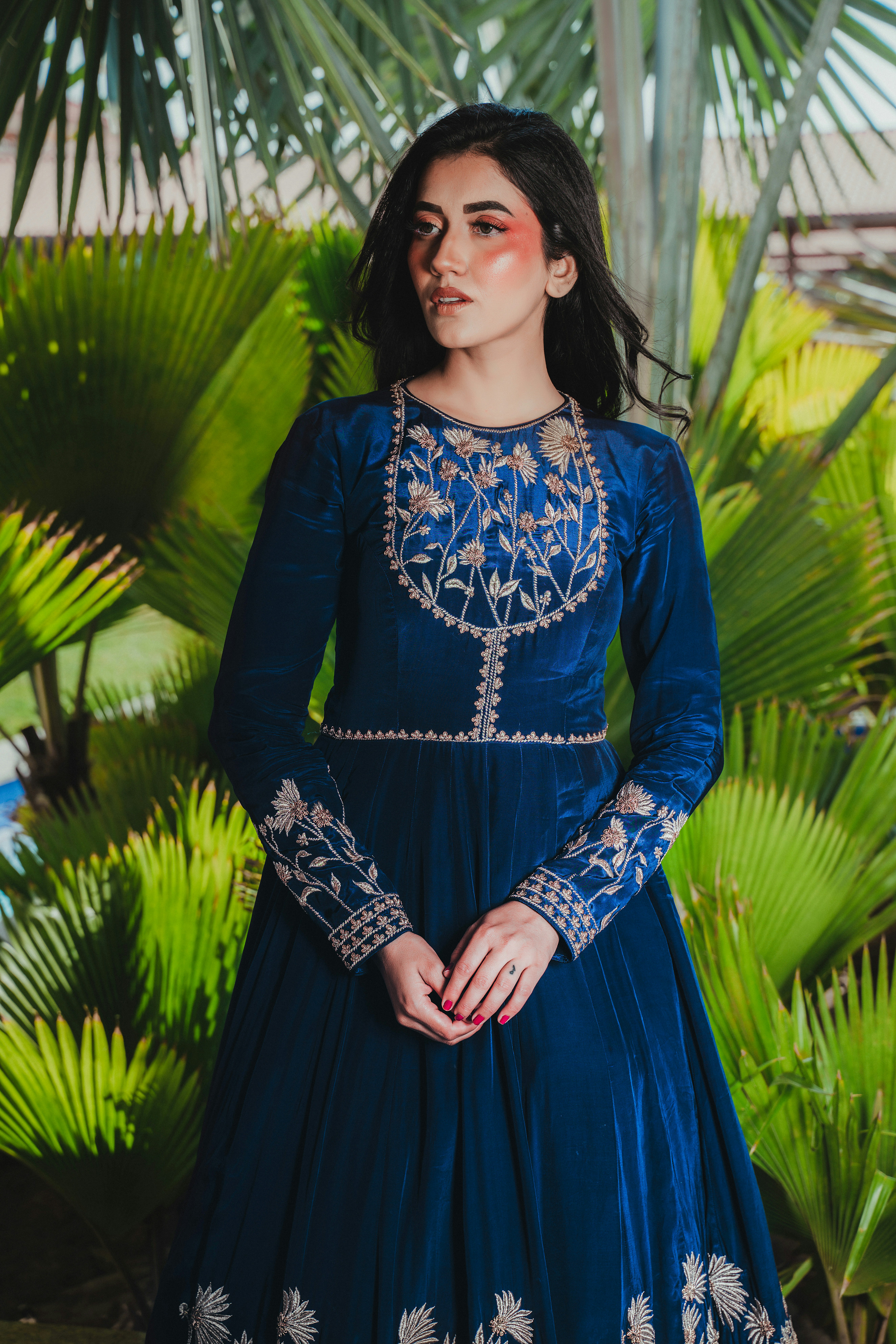Woman in elegant blue embroidered velvet dress