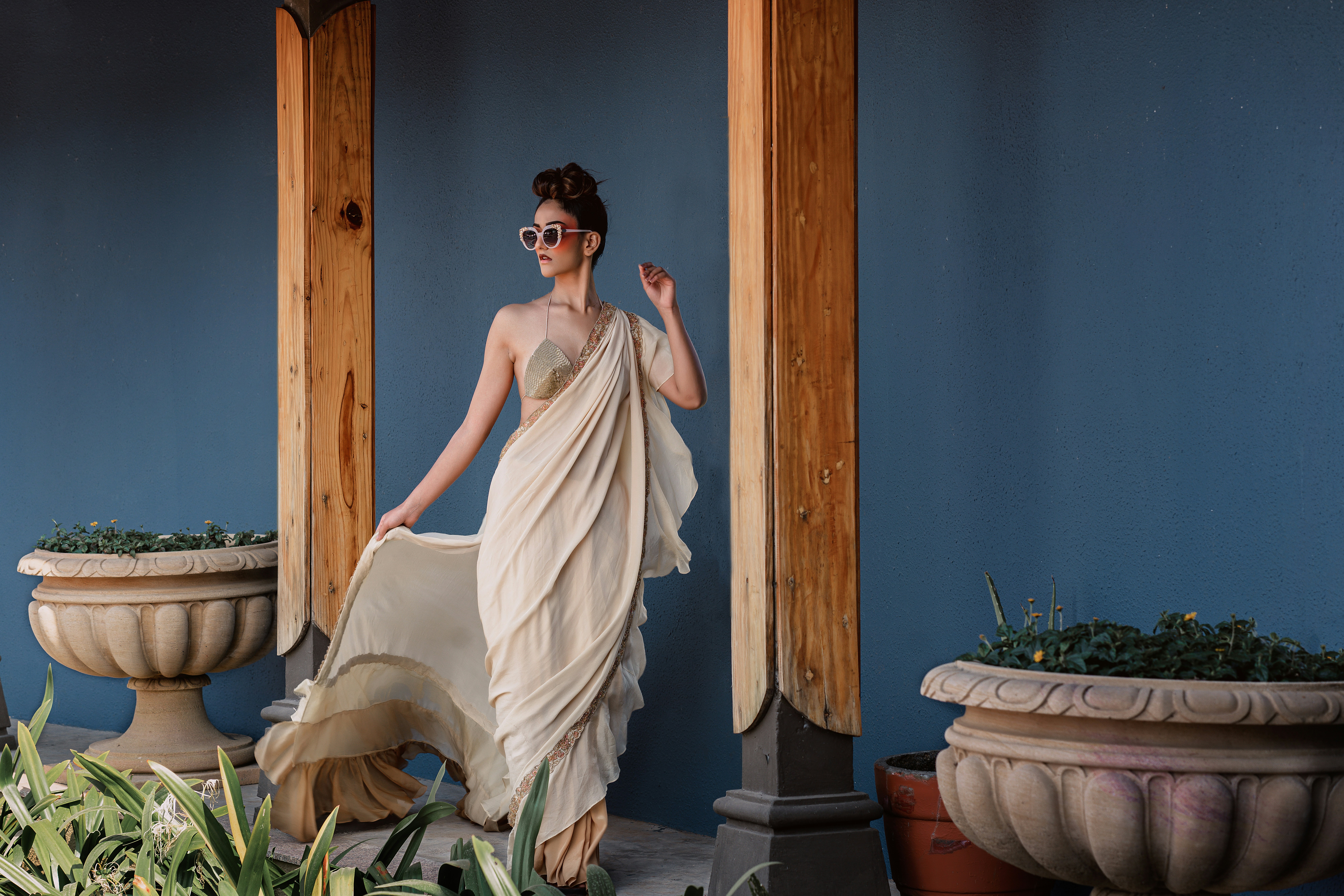 Woman in a draped dress and sunglasses