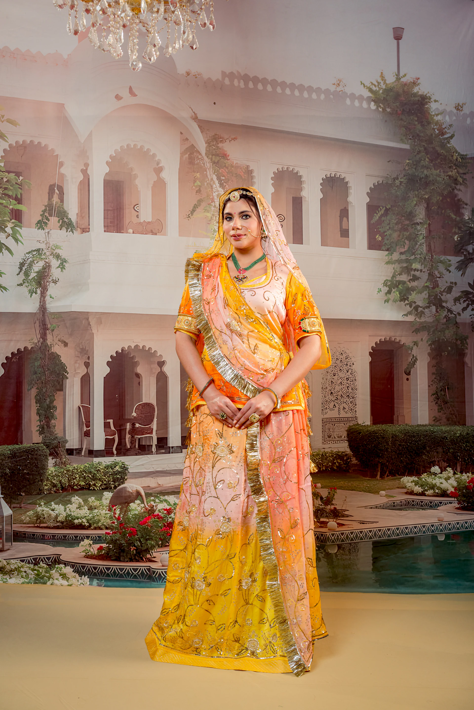Woman in a yellow lehenga in a palace courtyard