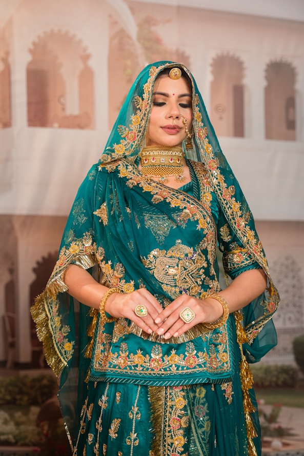 Woman in ornate teal and gold indian attire