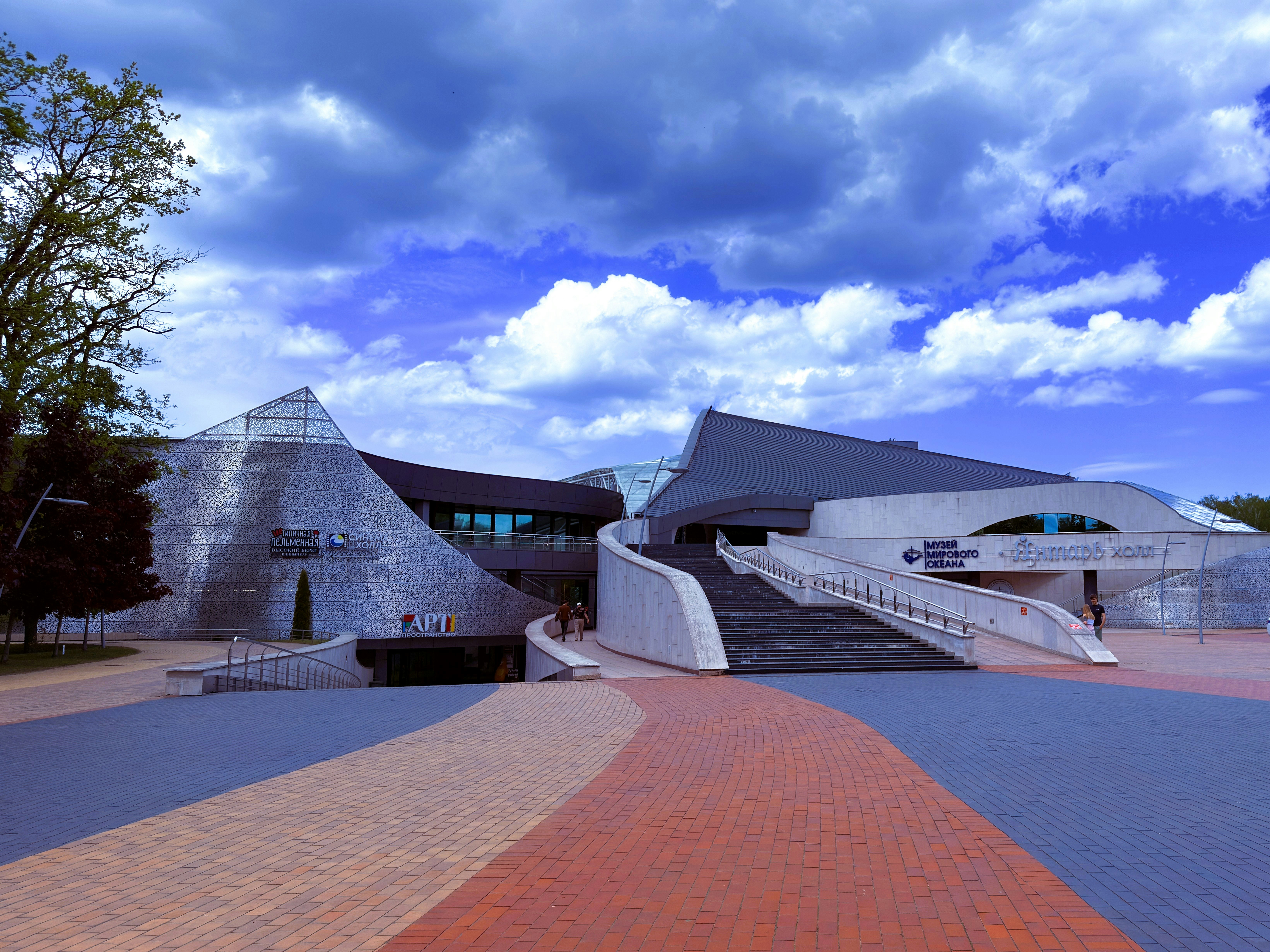 Modern building with unique architectural design under clouds