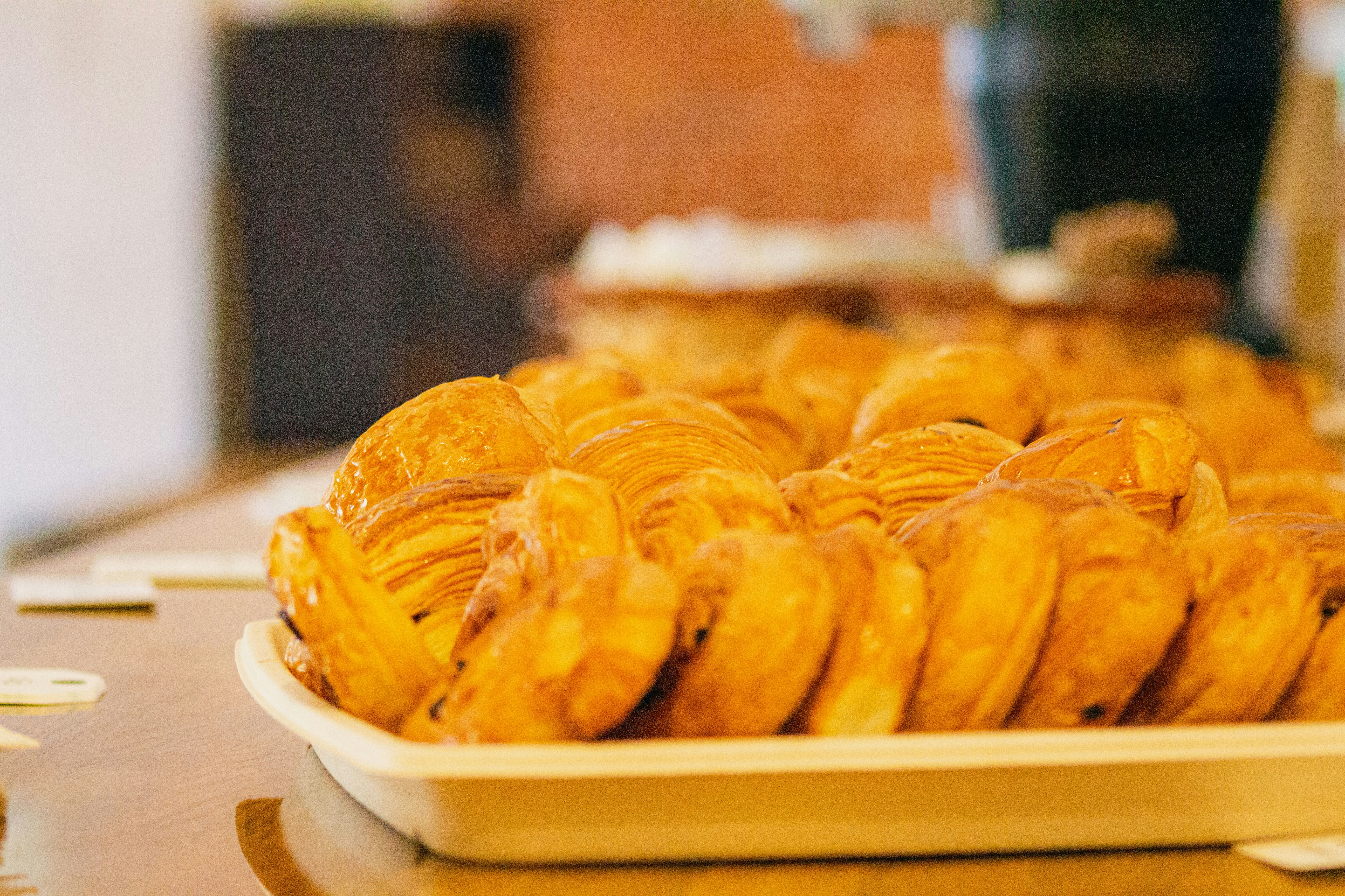 Golden croissants arranged on a white tray
