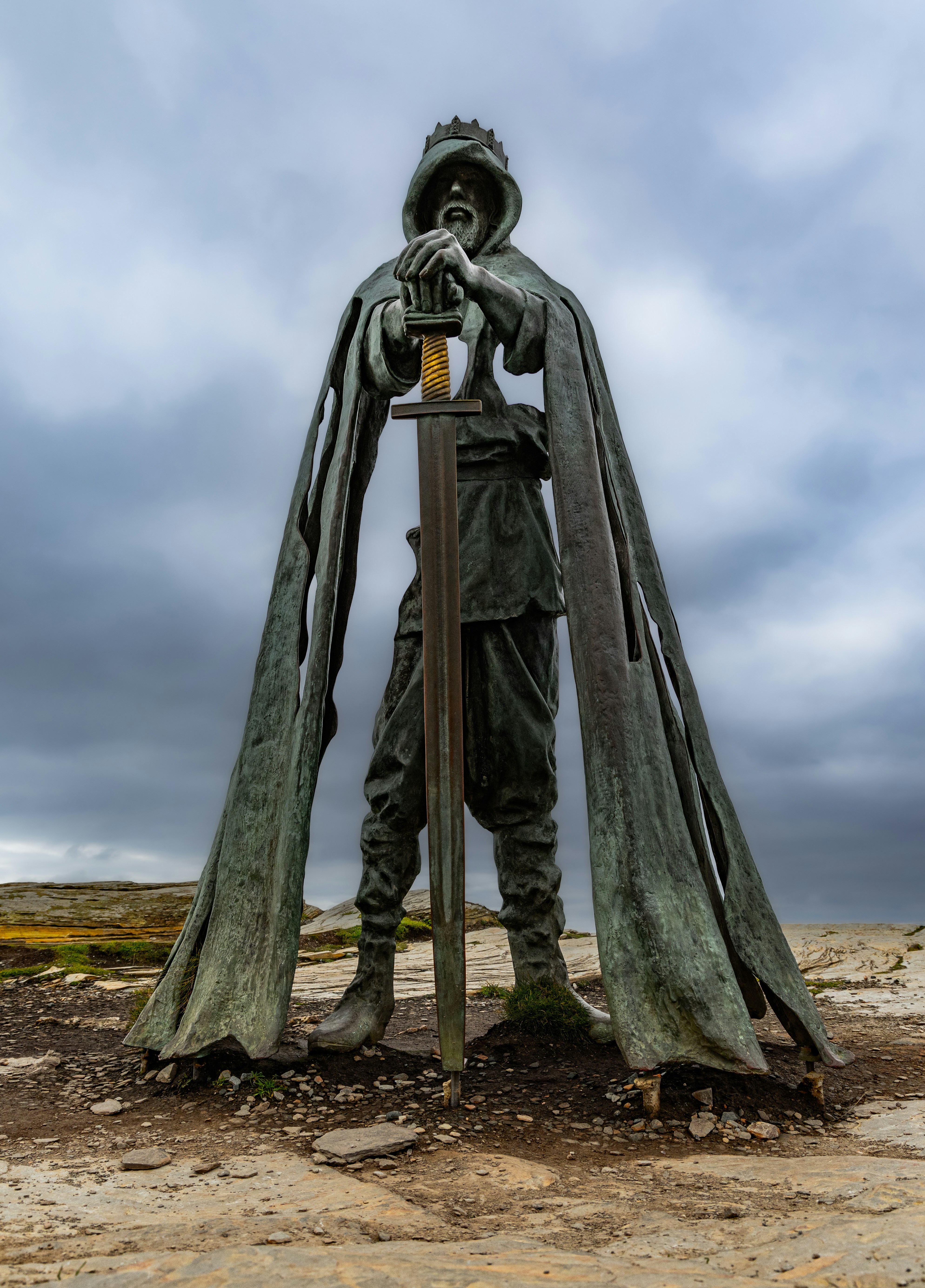 Statue of a king holding a sword with a crown