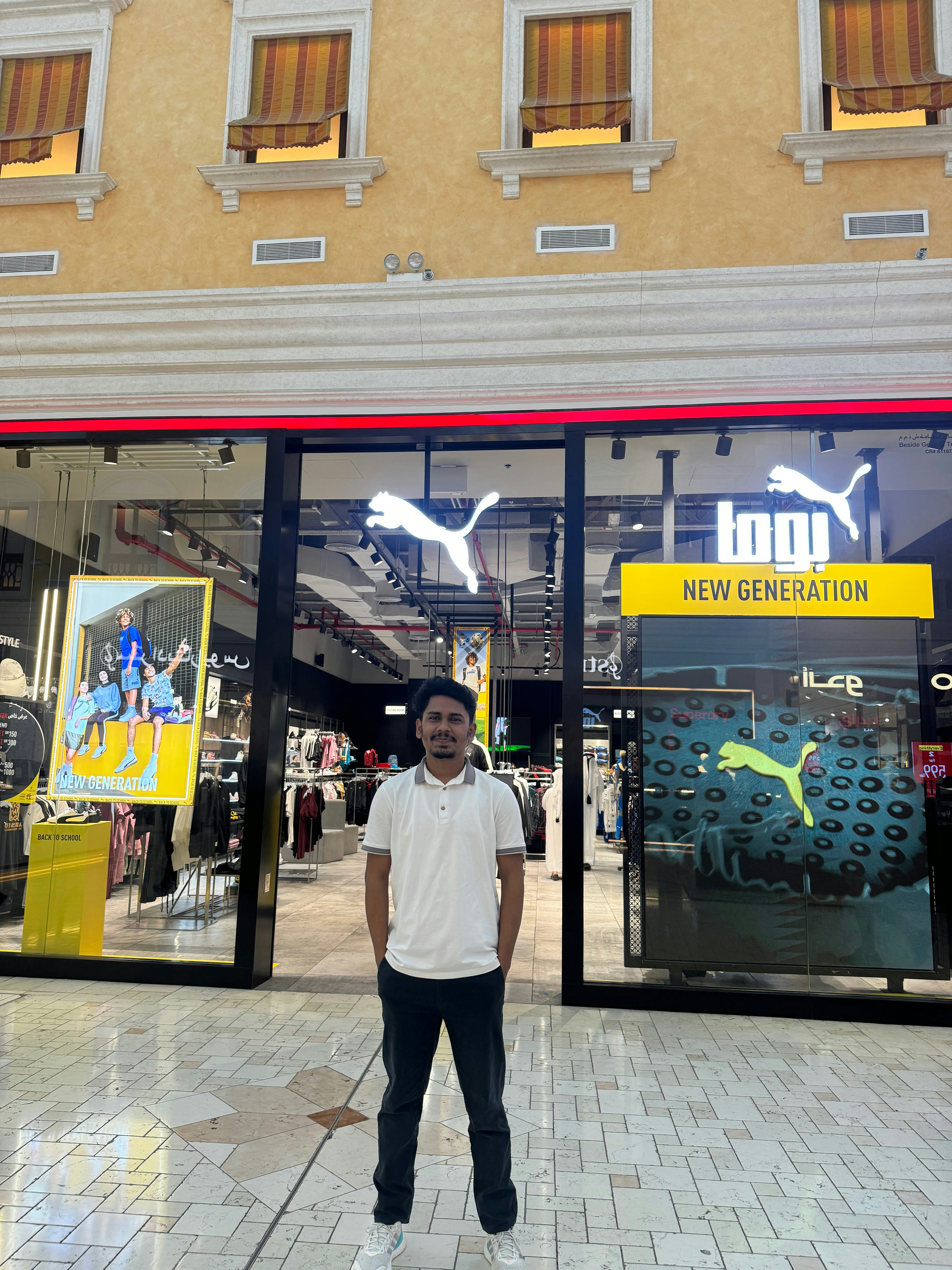 Man standing in front of a puma store.
