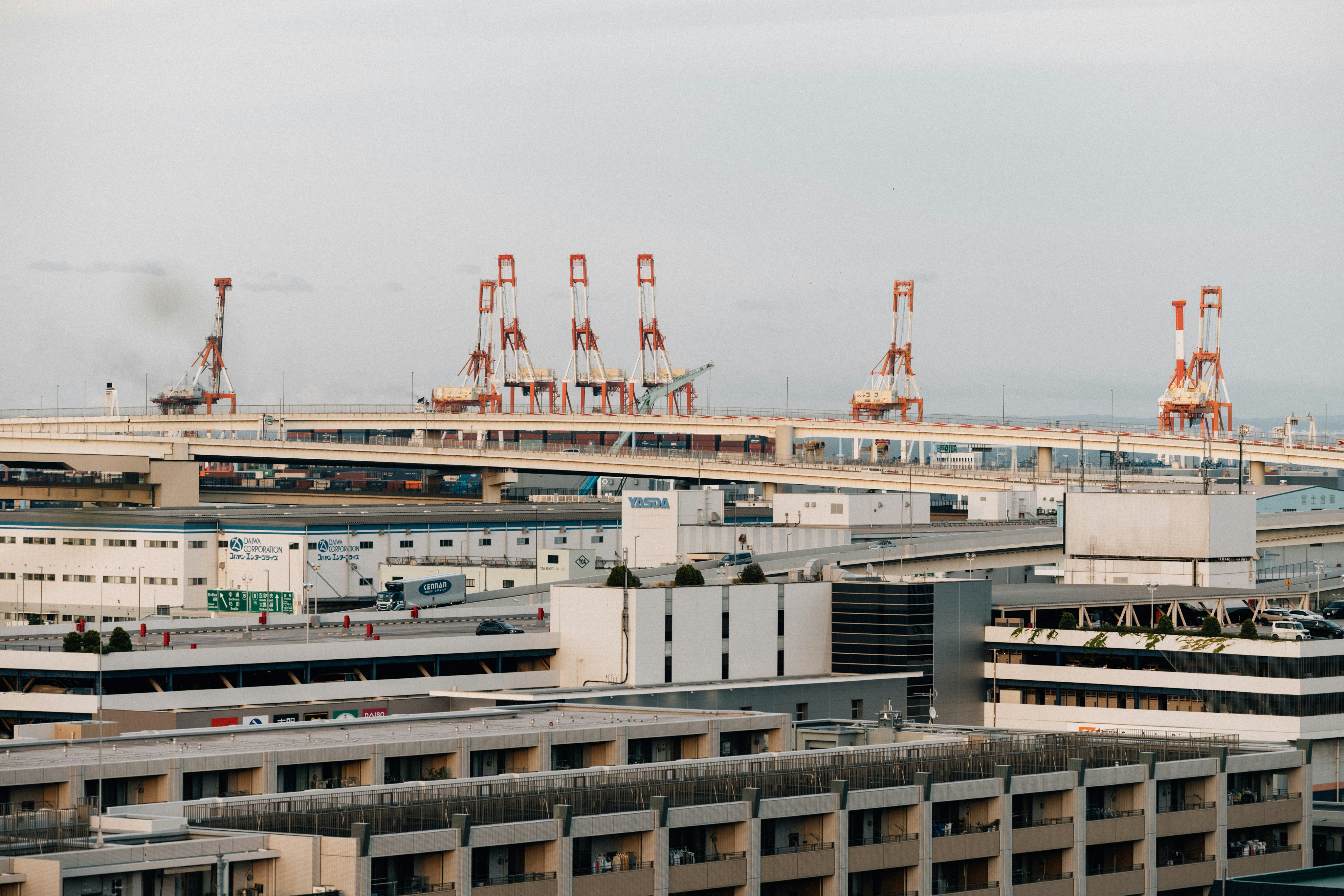 Industrial cranes and buildings under a cloudy sky