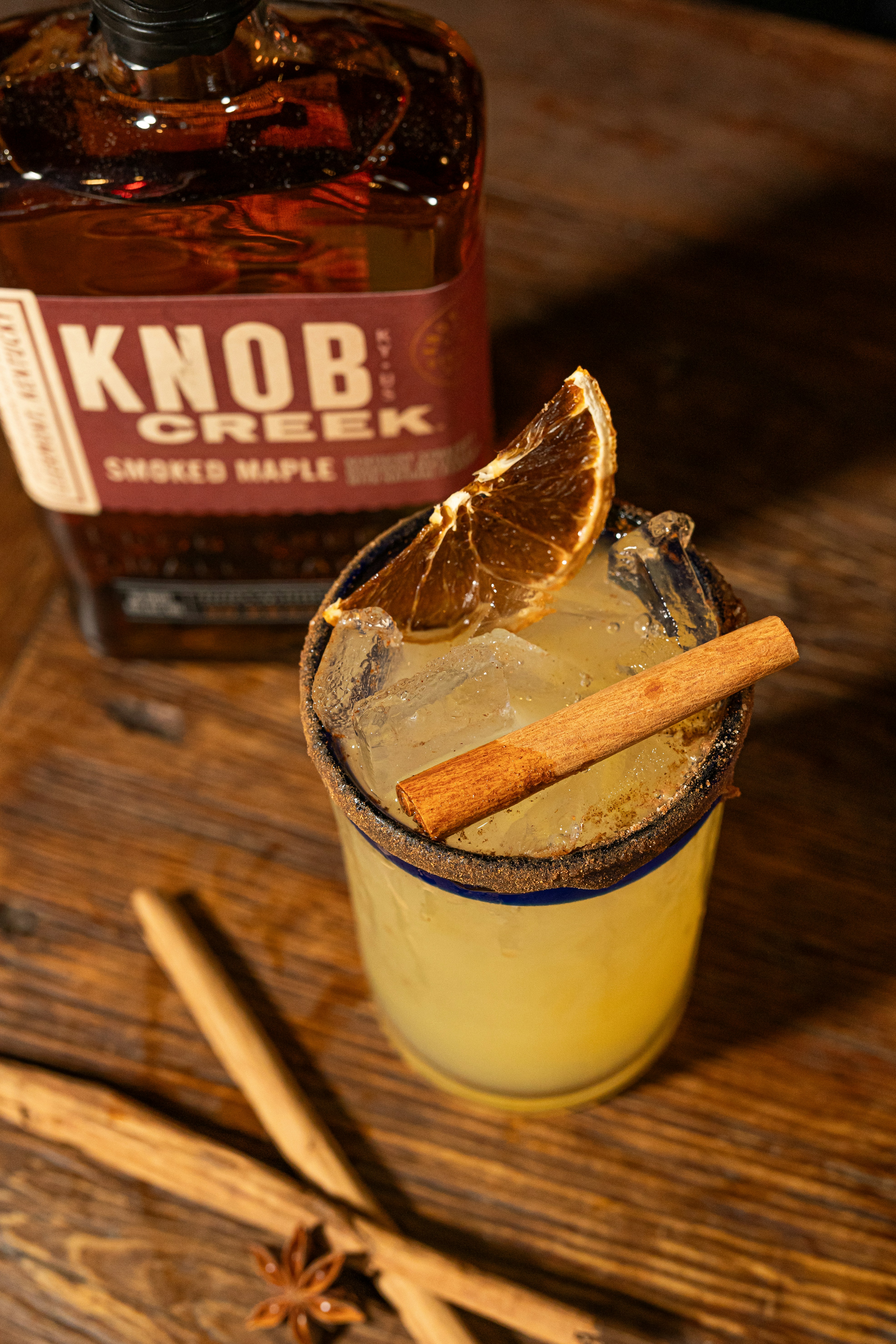 Cocktail with orange slice and cinnamon stick