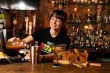 Bartender pouring drink behind a bar counter