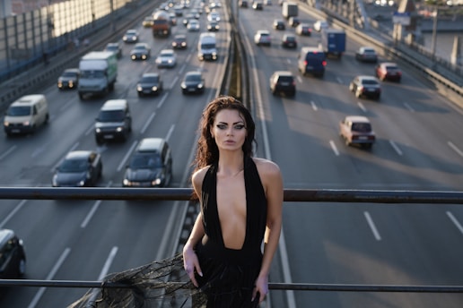 Woman in black dress on highway overpass