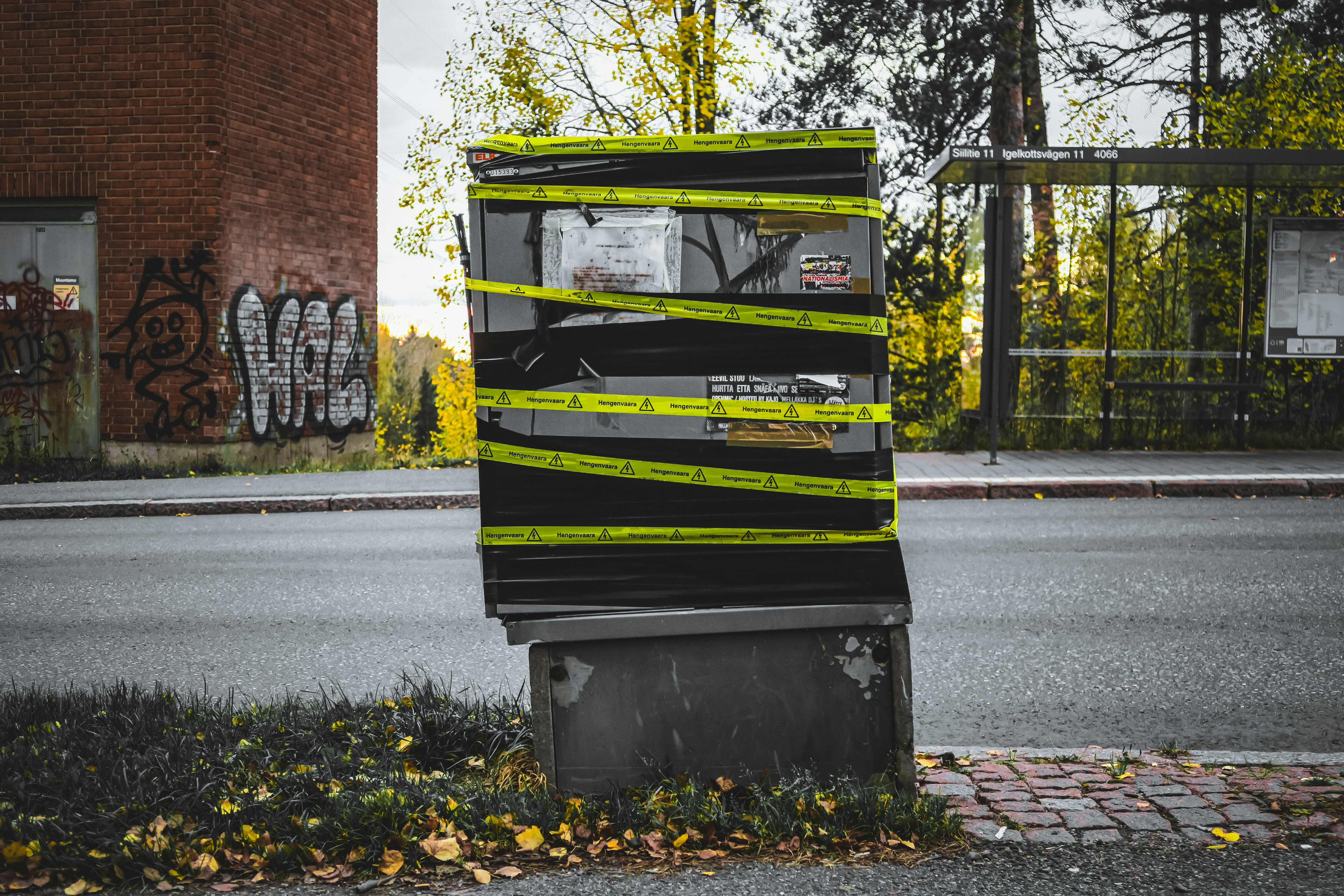 Box covered in black tape and yellow caution tape