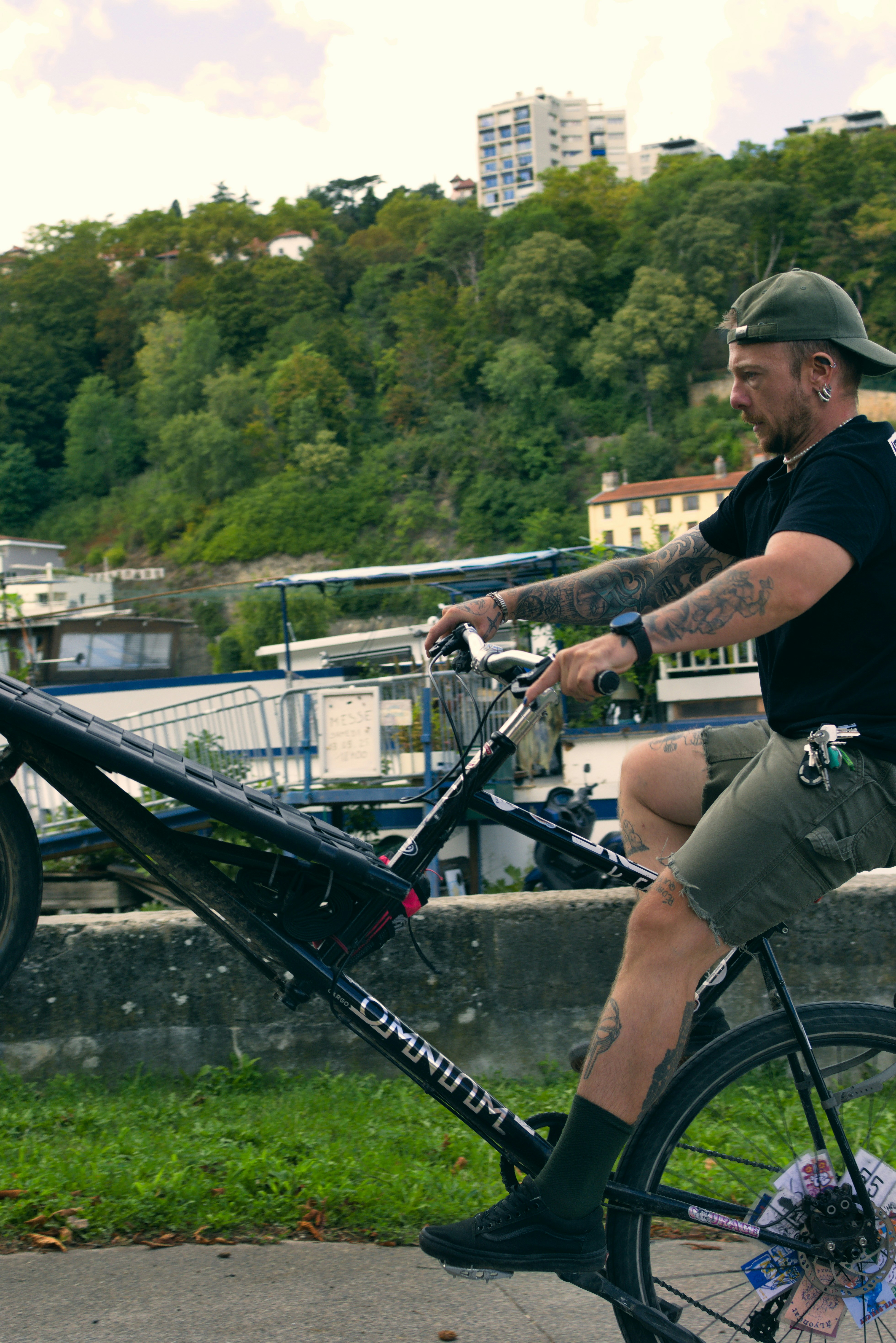 Man riding a bicycle with his front wheel lifted.