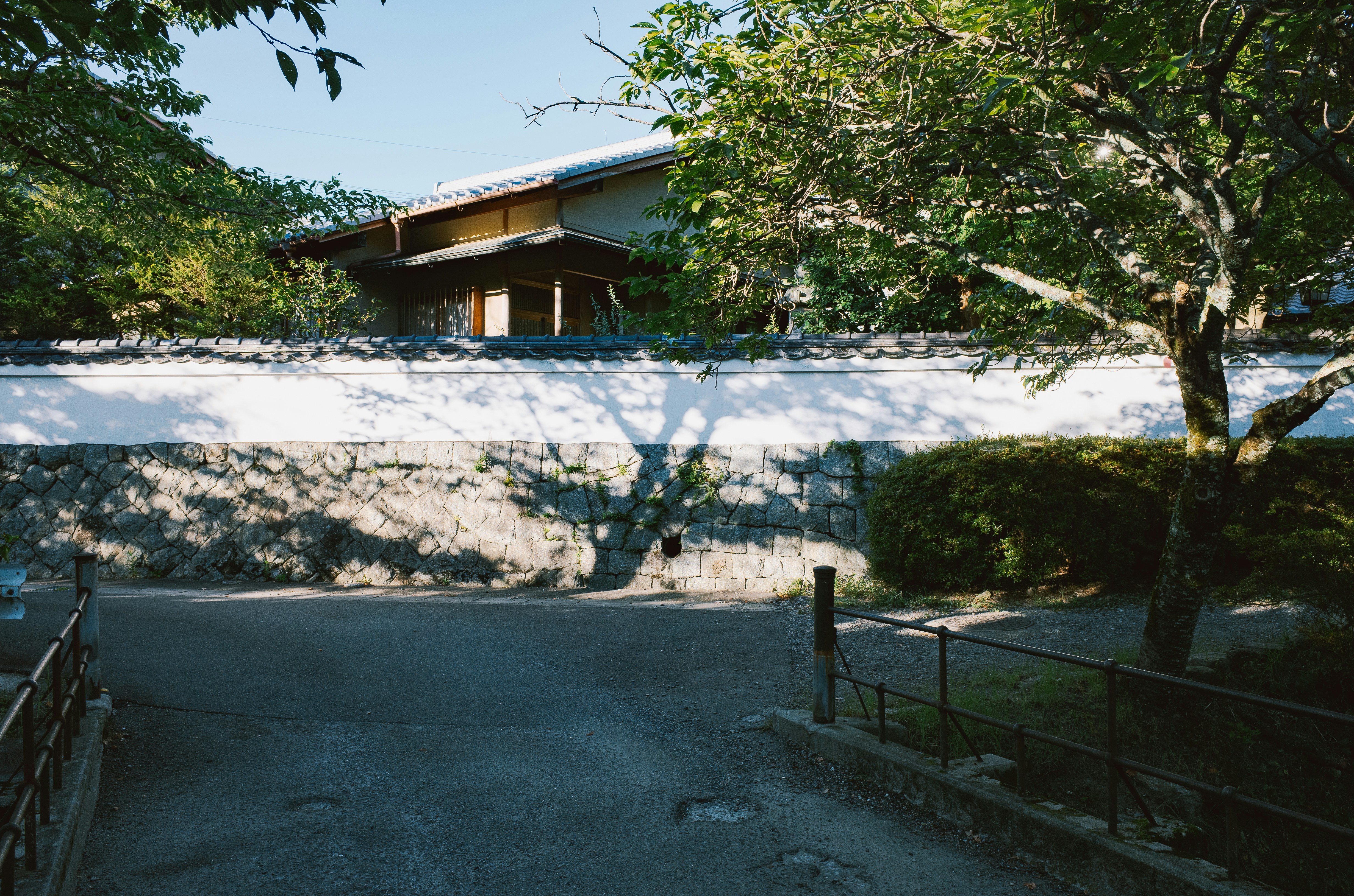 Stop image for Portland to Crater Lake: 3-Day Nature Adventure - Traditional japanese building behind a white wall -  in Pacific Northwest & West Coast - Photo by PJH on Unsplash