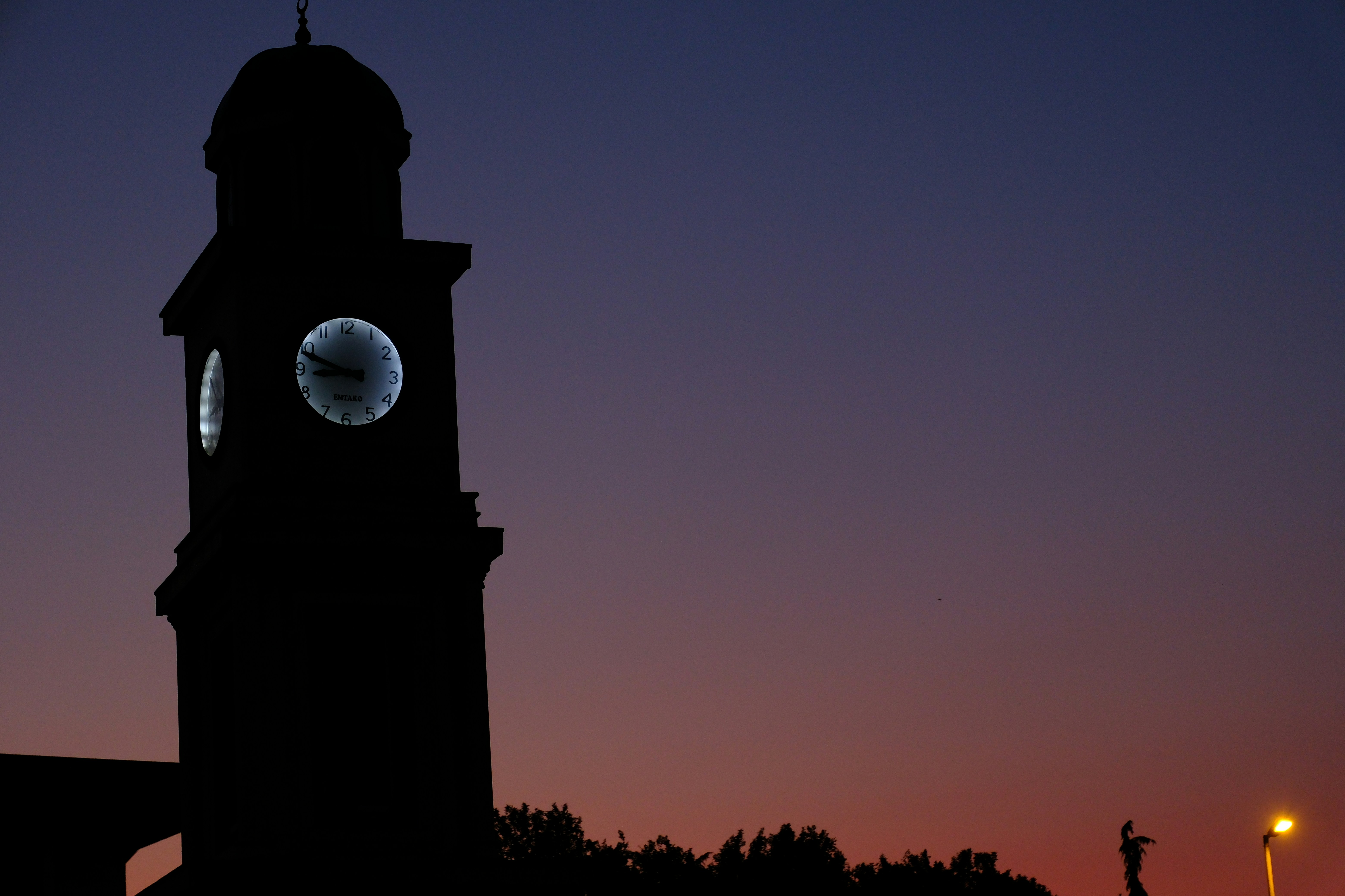 Clock tower silhouette against a twilight sky