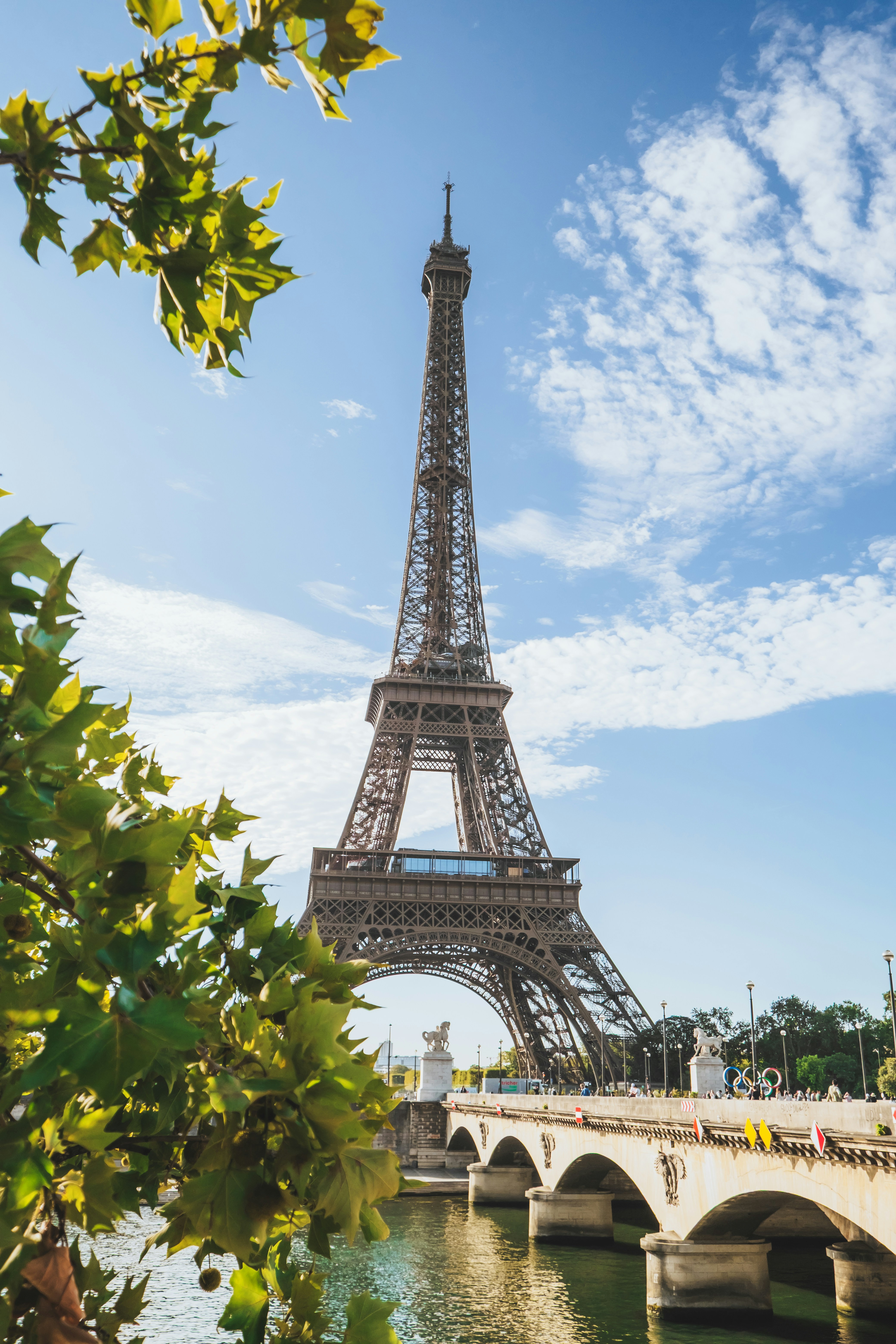Eiffel tower with bridge and river on a sunny day