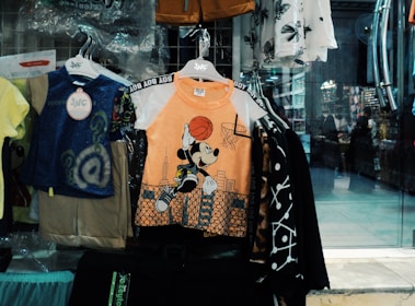 Children's clothes displayed in a store window.