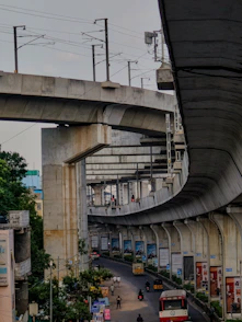 Elevated metro line curves over a busy city street
