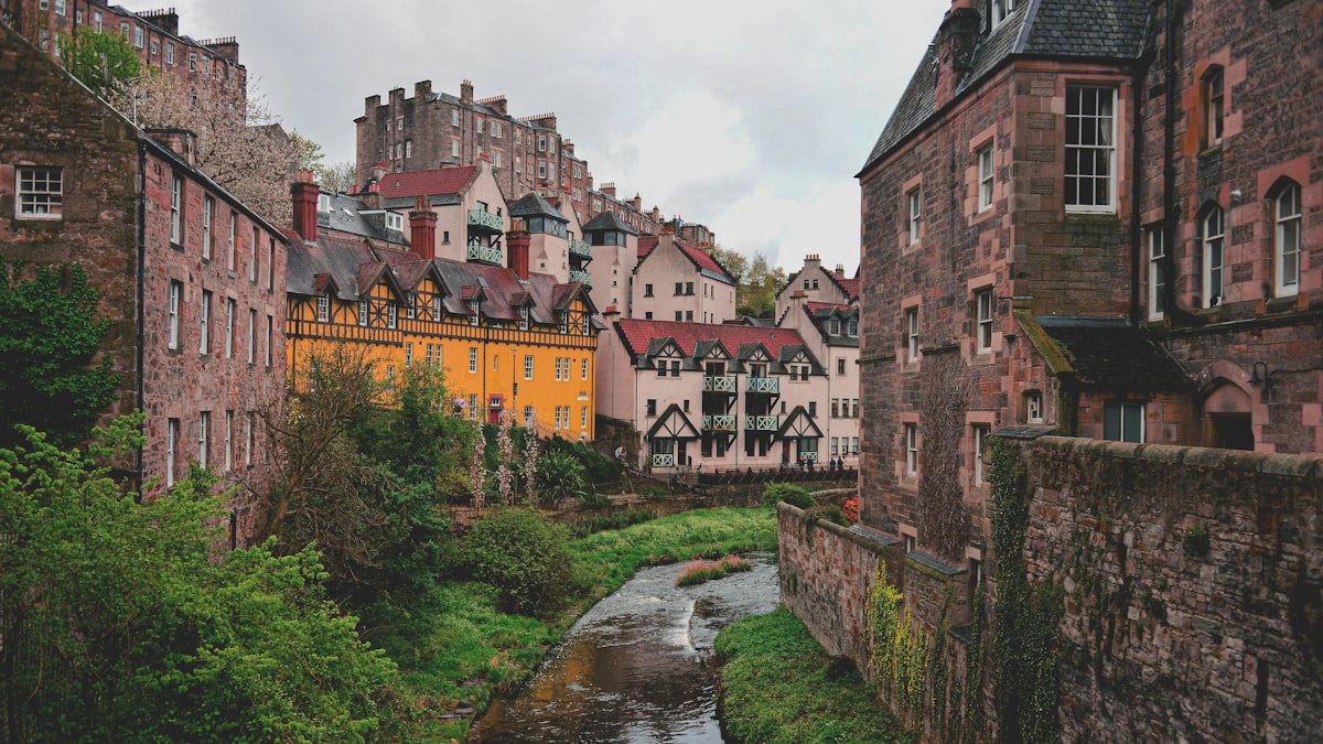 Edinburgh October — historic stone buildings lining a stream through the autumn city