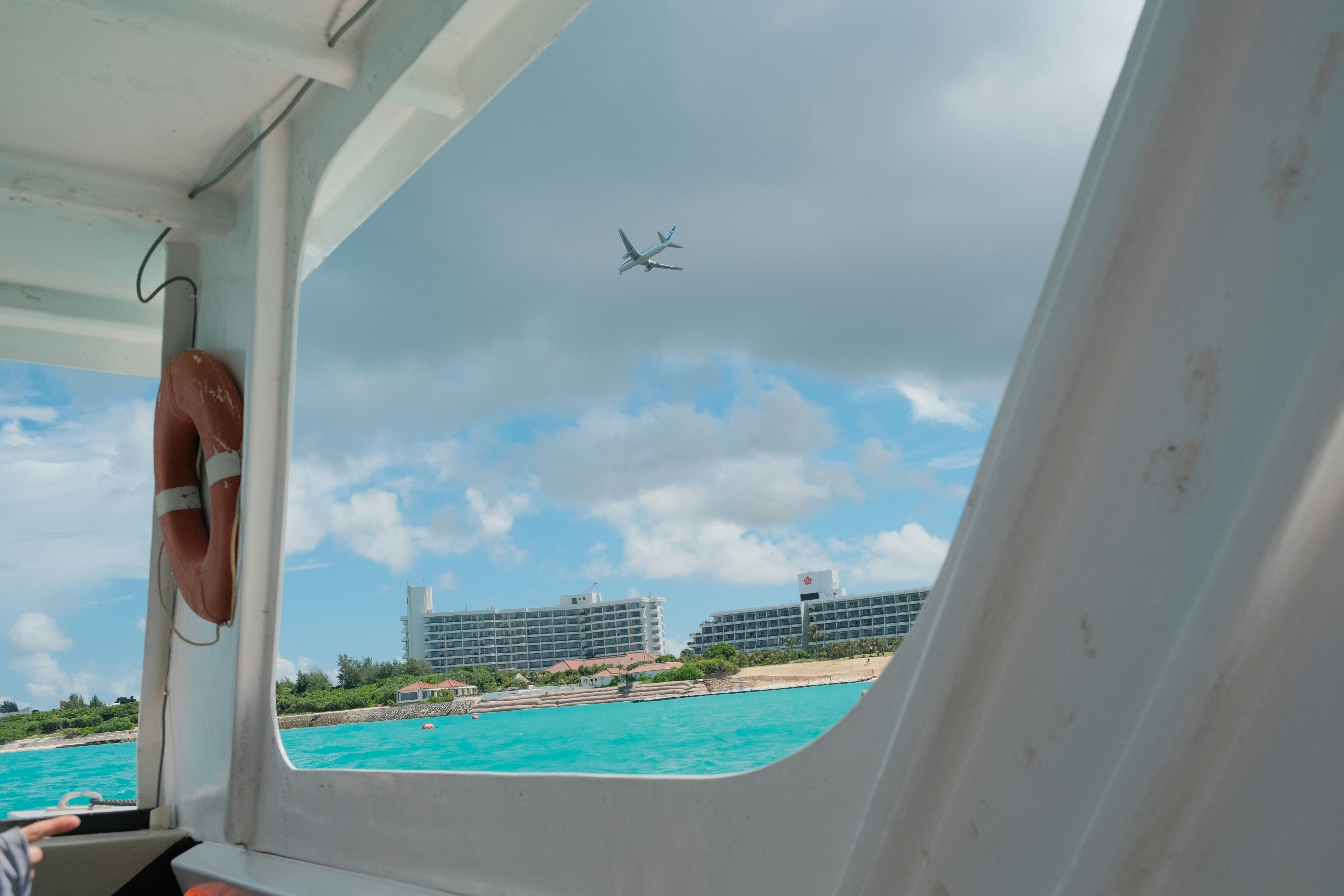 tropical resort with an airplane flying overhead - air ticket promotion