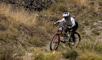 Mountain biker descending a grassy slope