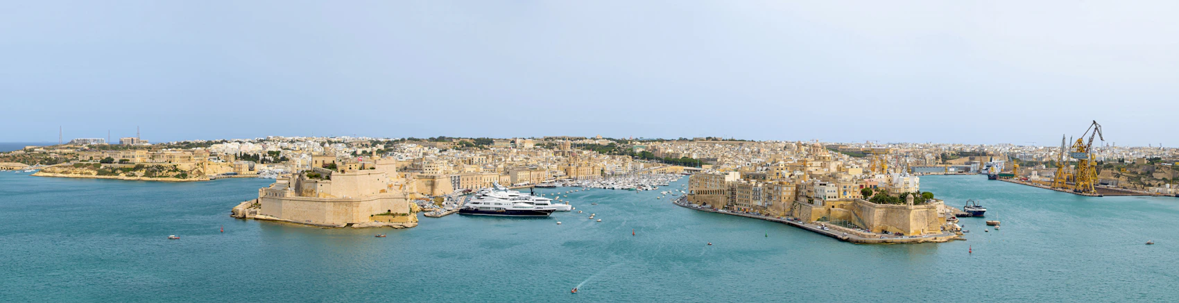 A wide panorama across Malta's Grand Harbour with historic fortifications and the Three Cities