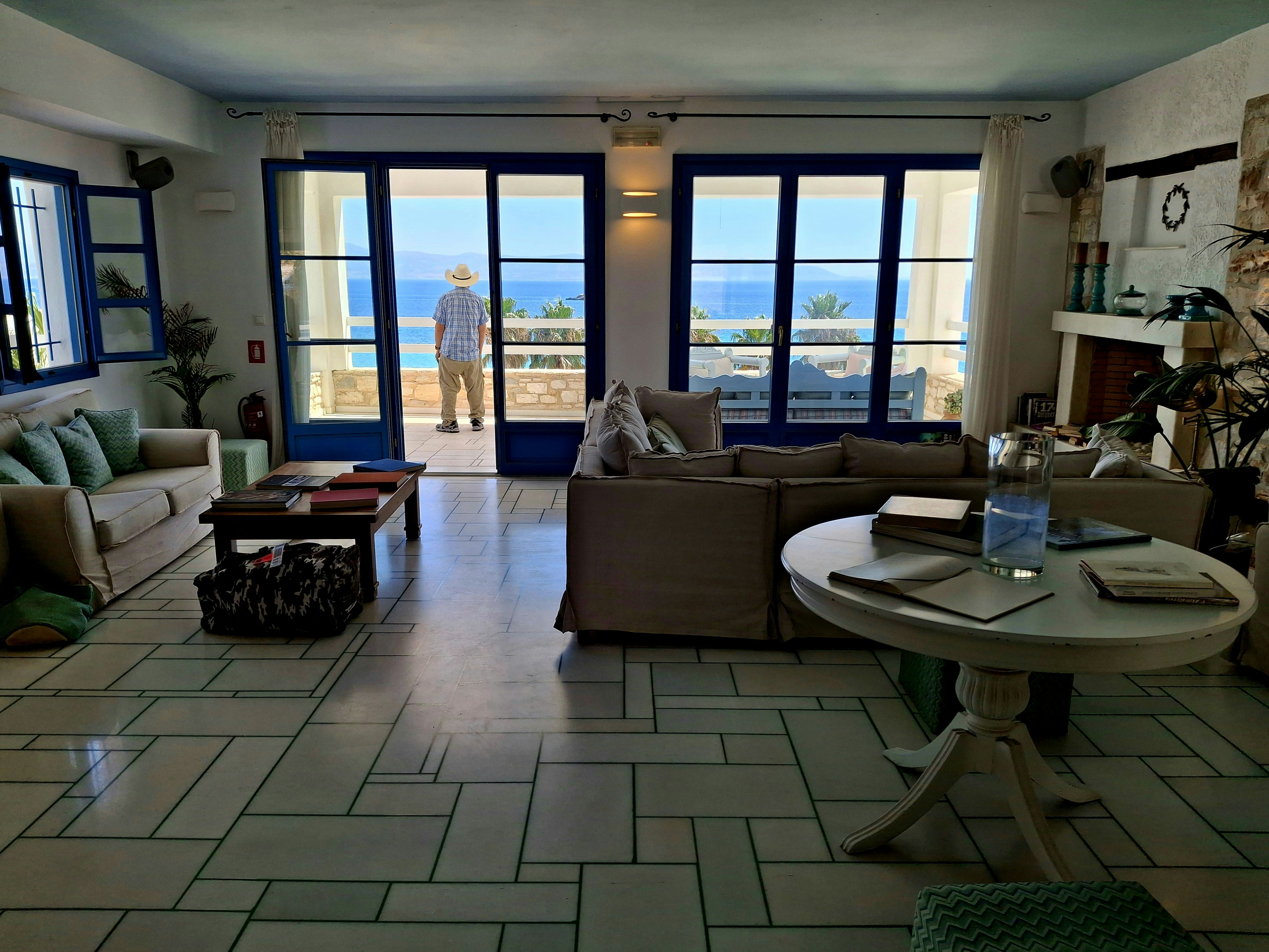 Living room with ocean view and person standing at door