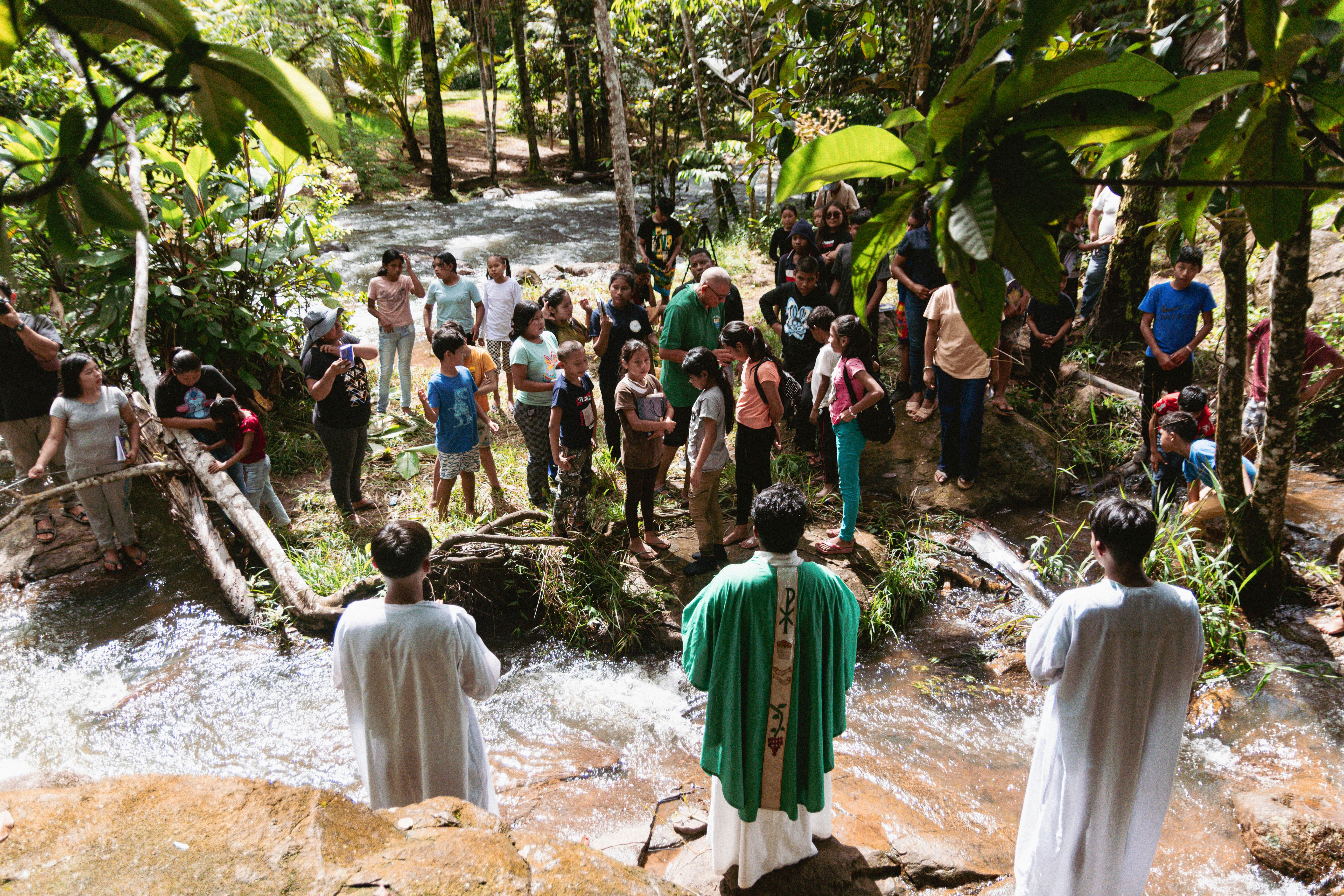Priests baptizing people in a river
