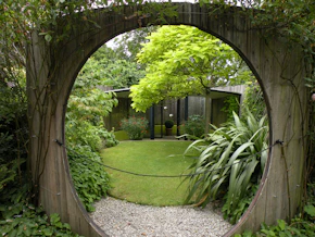 Circular wooden gateway to a lush green garden