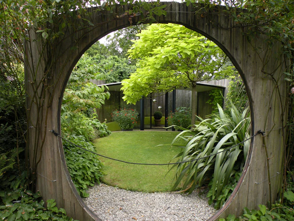 Circular wooden gateway to a lush green garden